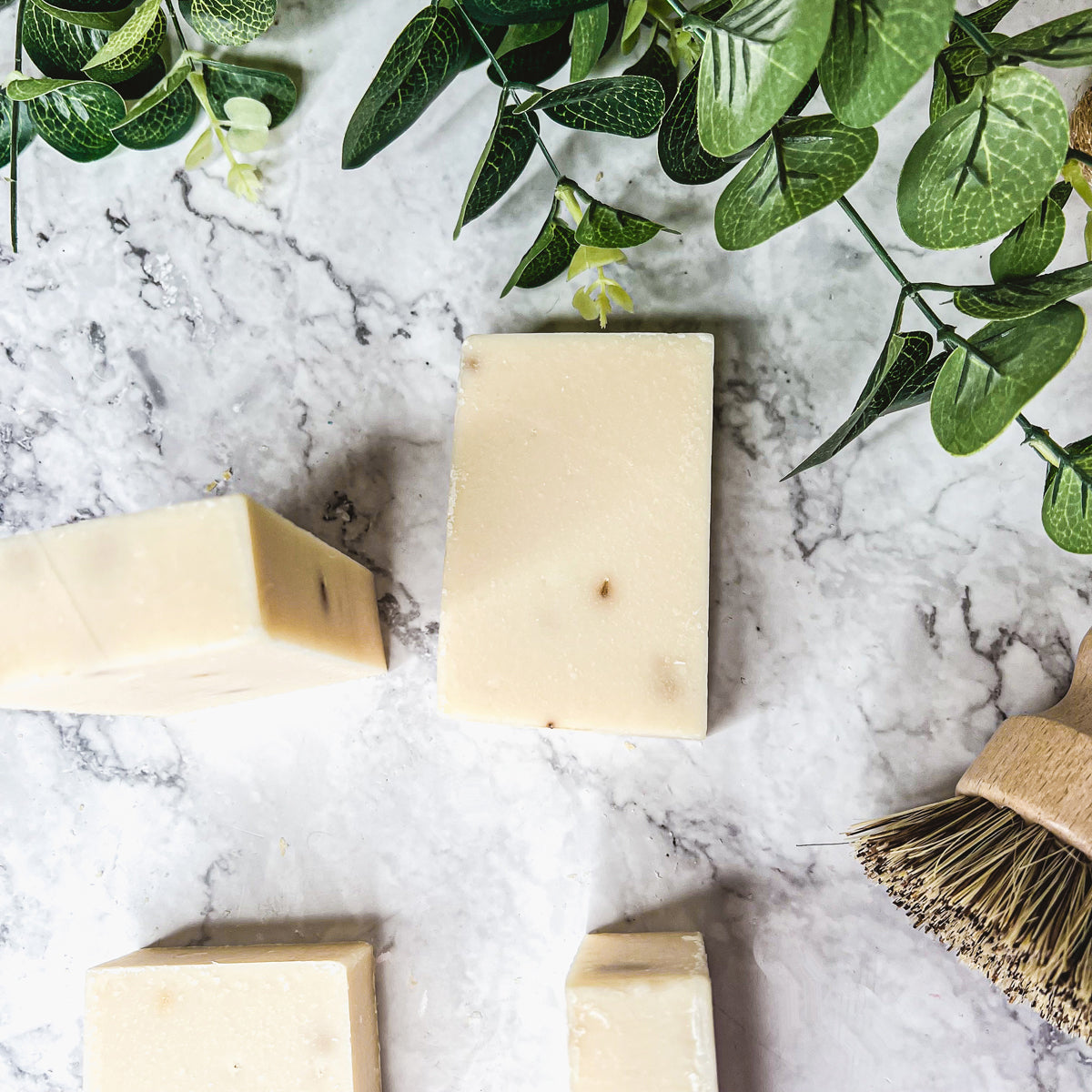 A handcrafted bar of Lavender Ylang Ylang soap featuring lavender buds and a blend of natural oils, showcasing its unique design and texture.