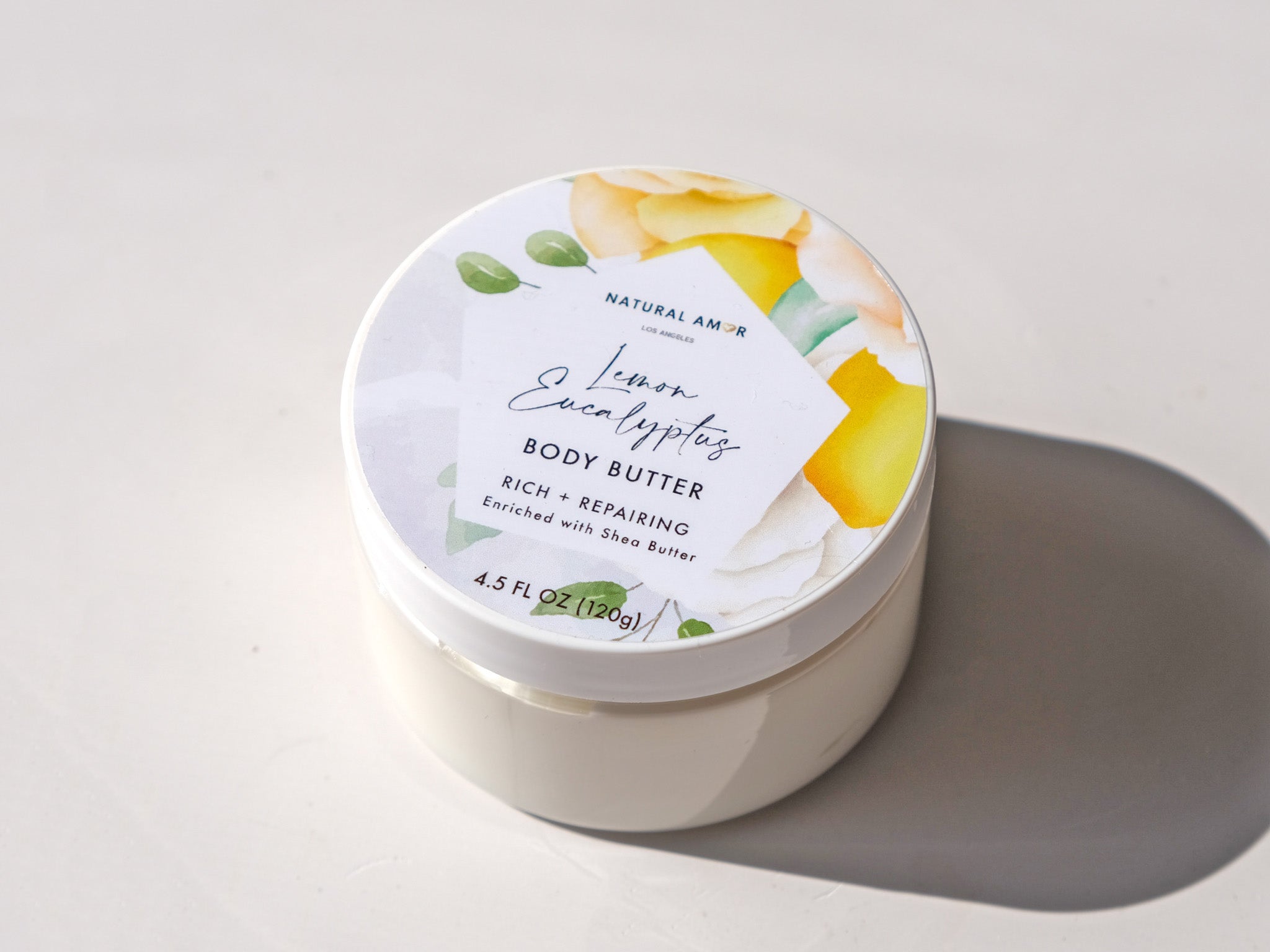 Lemon Eucalyptus Emulsified Body Butter in a jar, showcasing its creamy texture and vibrant packaging.