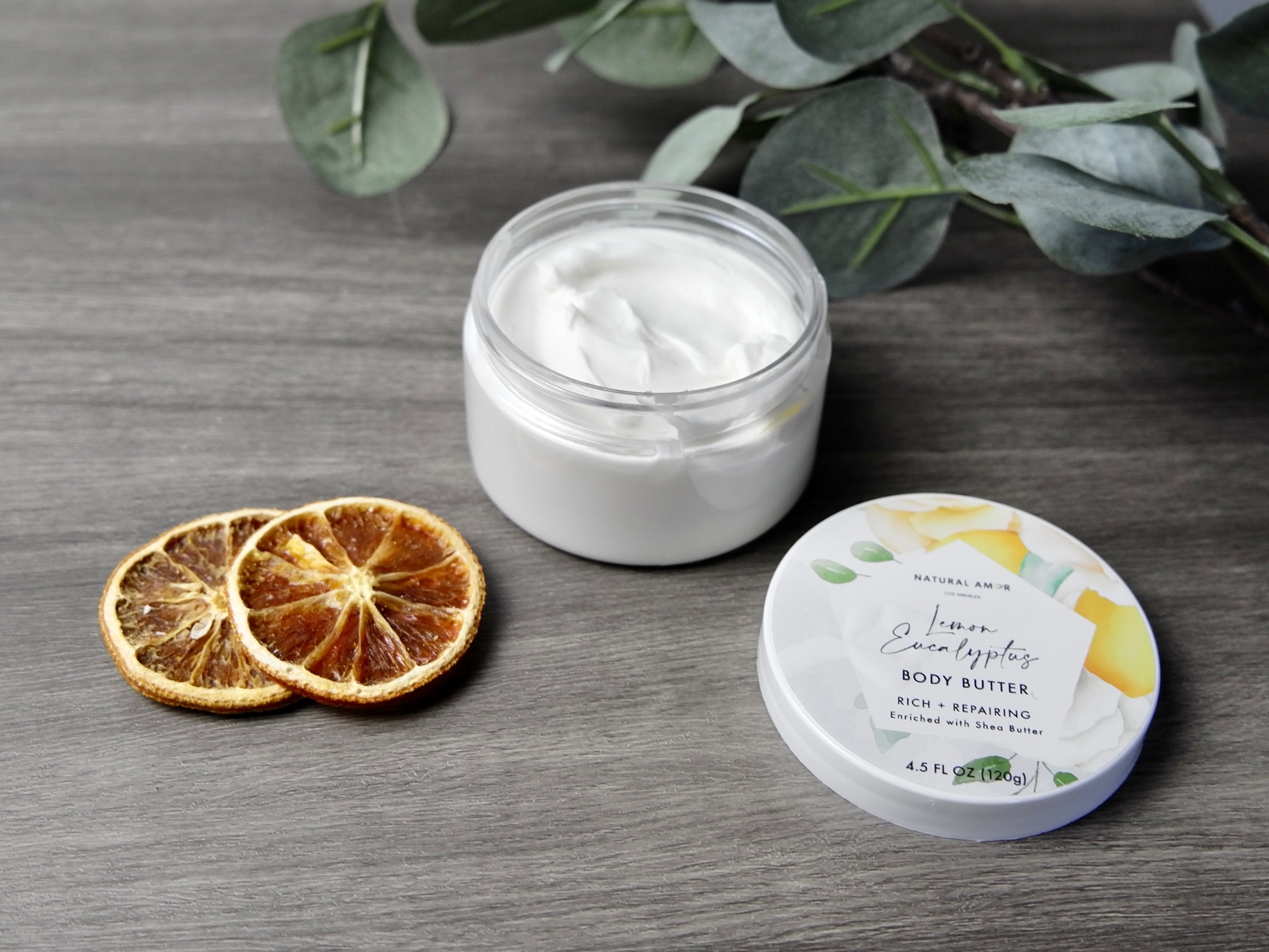 Lemon Eucalyptus Emulsified Body Butter in a jar, showcasing its creamy texture and vibrant packaging.