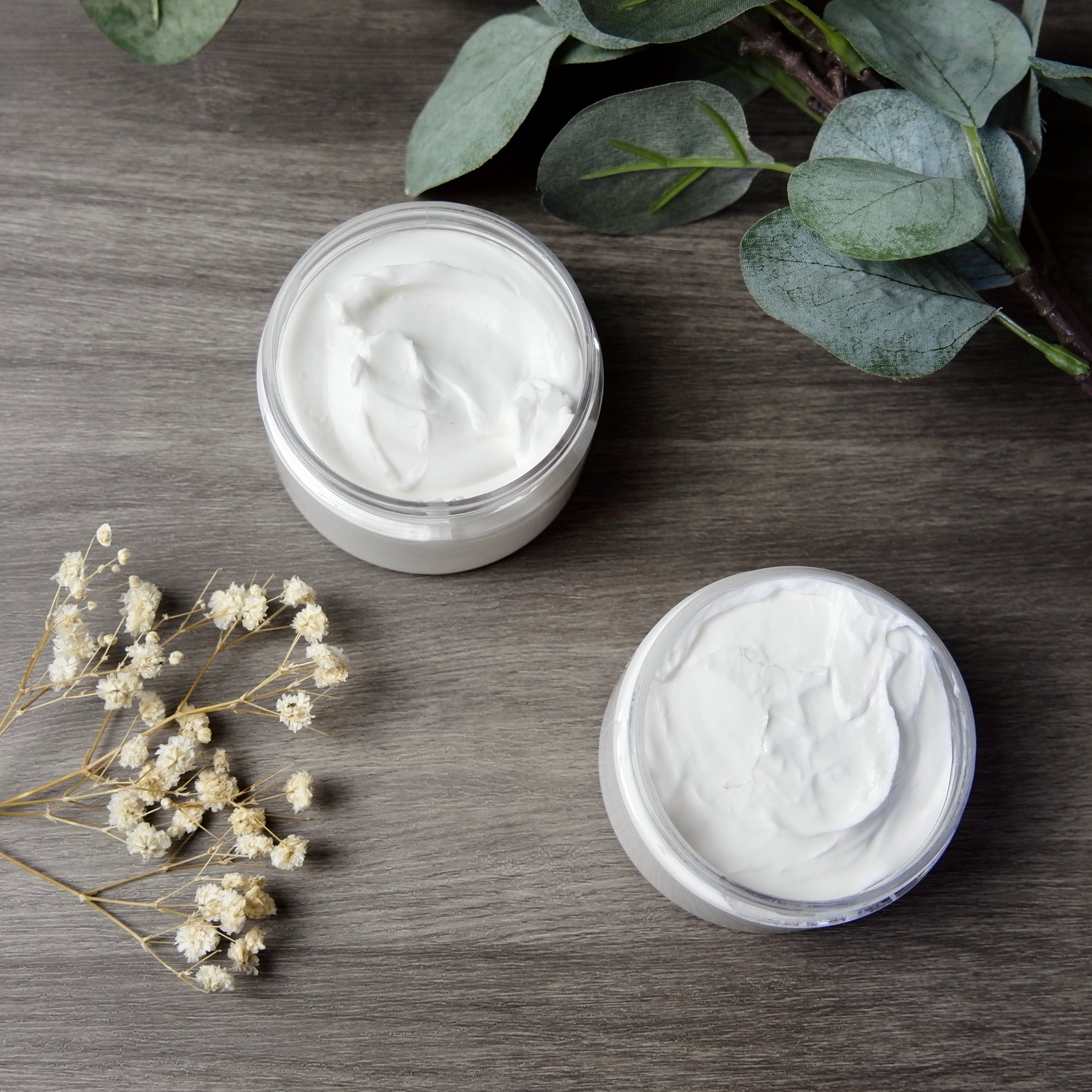 Lemon Eucalyptus Emulsified Body Butter in a jar, showcasing its creamy texture and vibrant packaging.