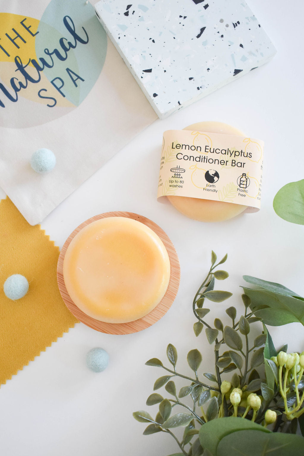 A vibrant solid conditioner bar infused with lemon and eucalyptus, showcasing its natural ingredients and eco-friendly packaging.