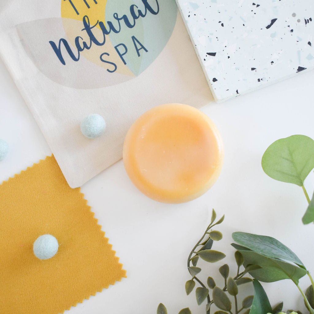 A vibrant solid conditioner bar infused with lemon and eucalyptus, showcasing its natural ingredients and eco-friendly packaging.