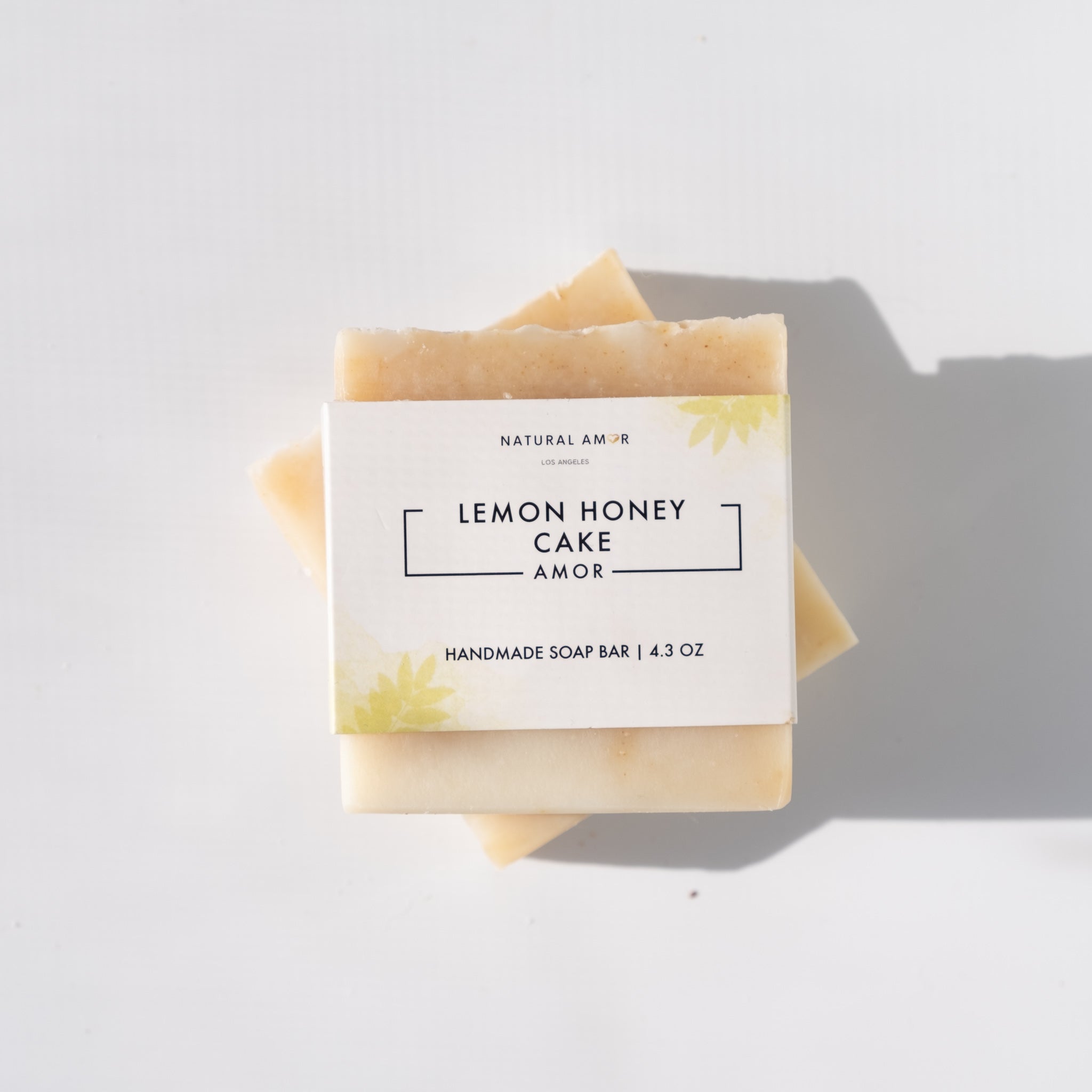 Lemon Honey Cake Soap Bar with a creamy texture and citrus scent, featuring natural ingredients like honey and turmeric.