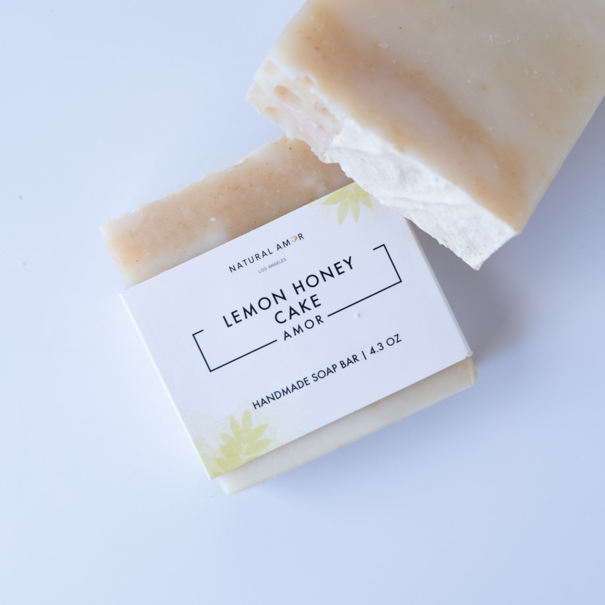 Lemon Honey Cake Soap Bar with a creamy texture and citrus scent, featuring natural ingredients like honey and turmeric.