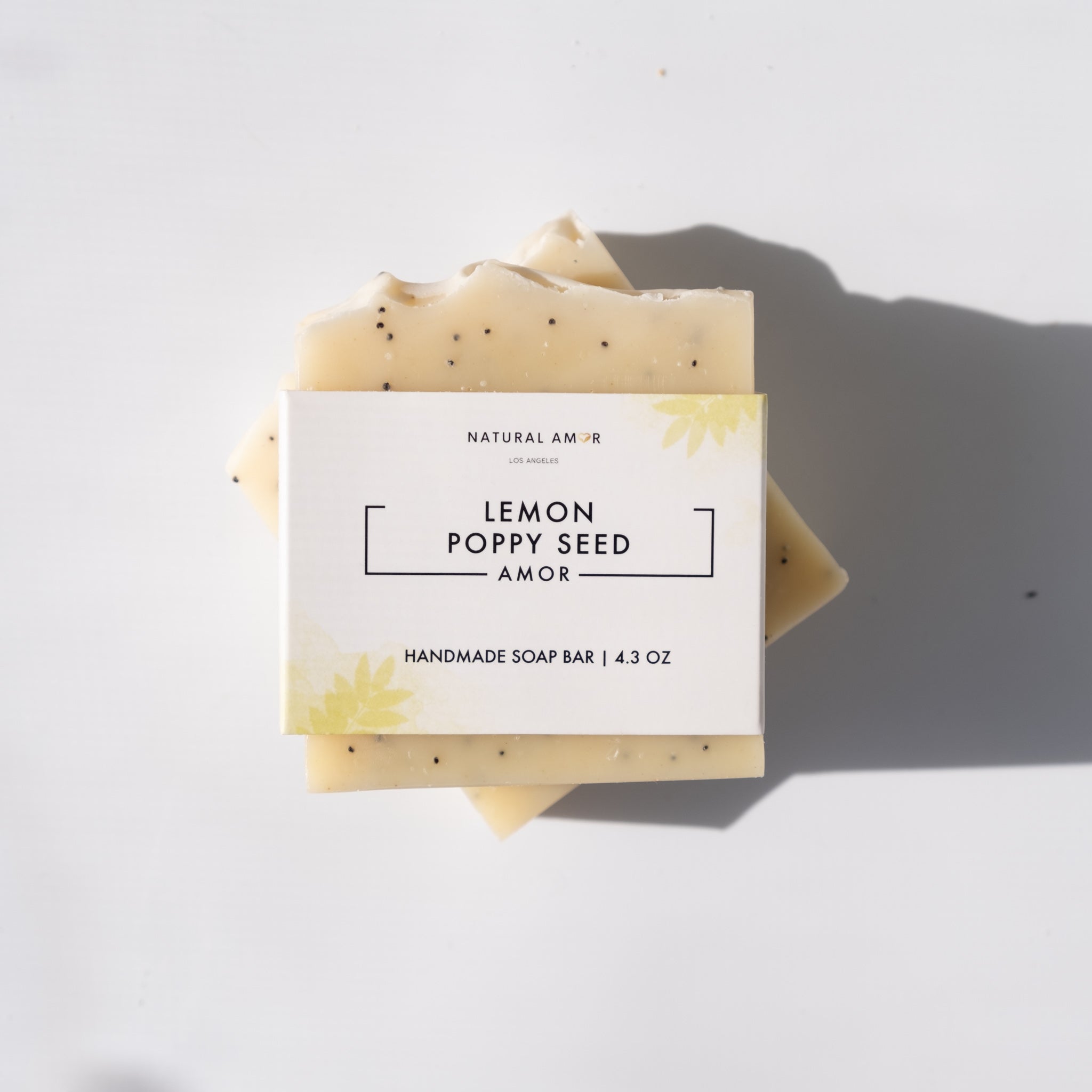 Lemon Poppyseed Soap Bar with poppy seeds and turmeric color, showcasing its natural ingredients and refreshing scent.