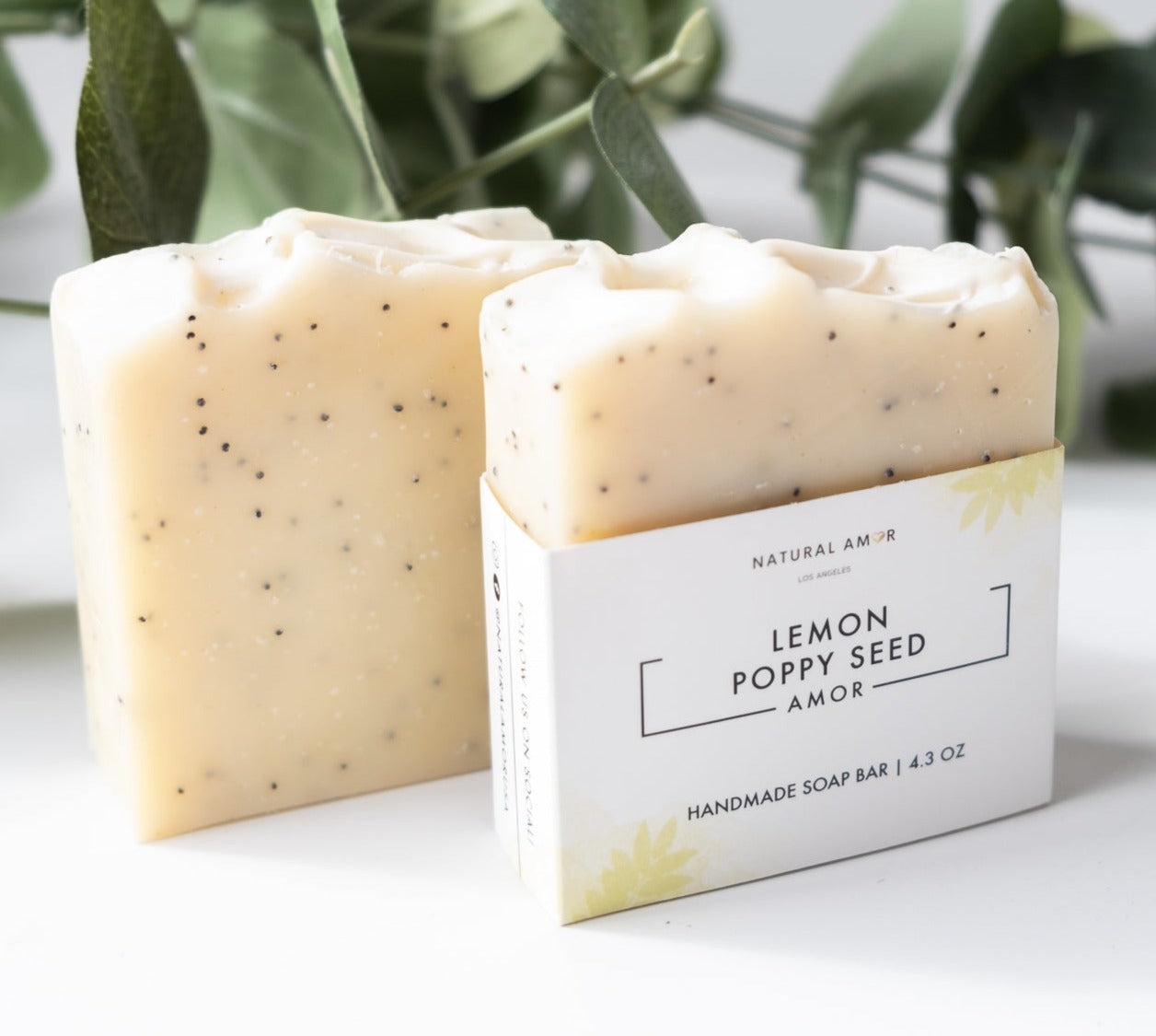 Lemon Poppyseed Soap Bar with poppy seeds and turmeric color, showcasing its natural ingredients and refreshing scent.