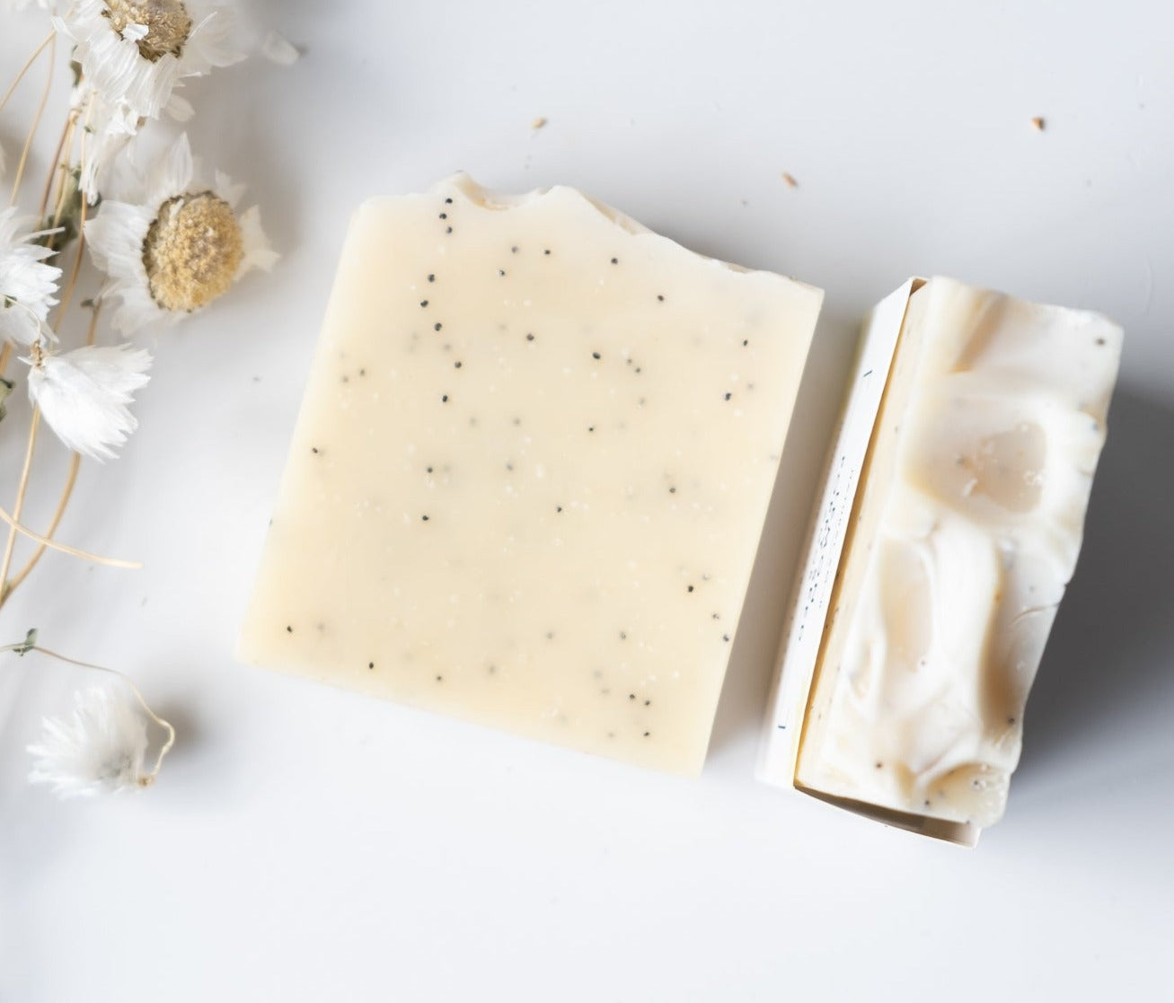 Lemon Poppyseed Soap Bar with poppy seeds and turmeric color, showcasing its natural ingredients and refreshing scent.