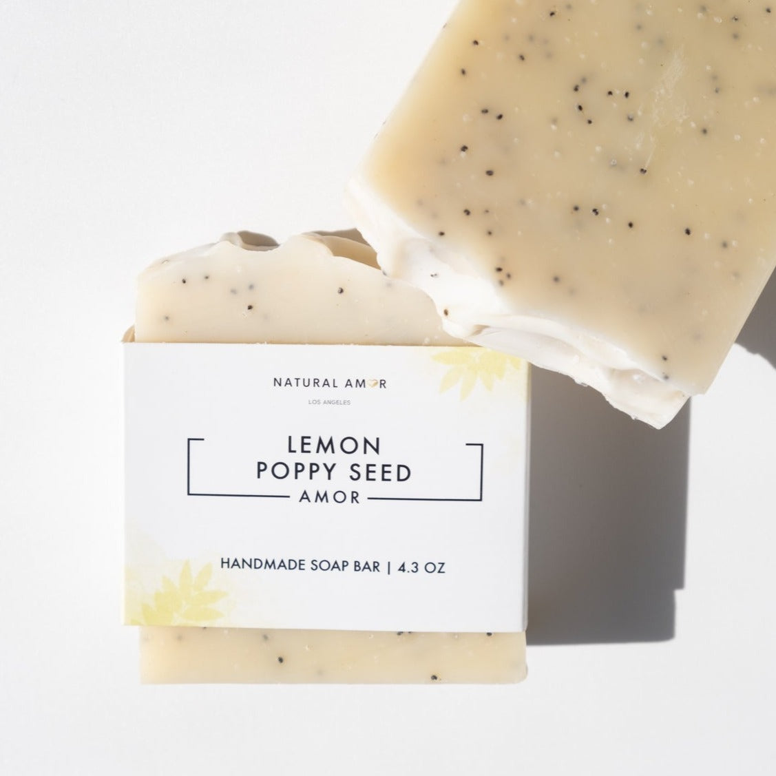 Lemon Poppyseed Soap Bar with poppy seeds and turmeric color, showcasing its natural ingredients and refreshing scent.