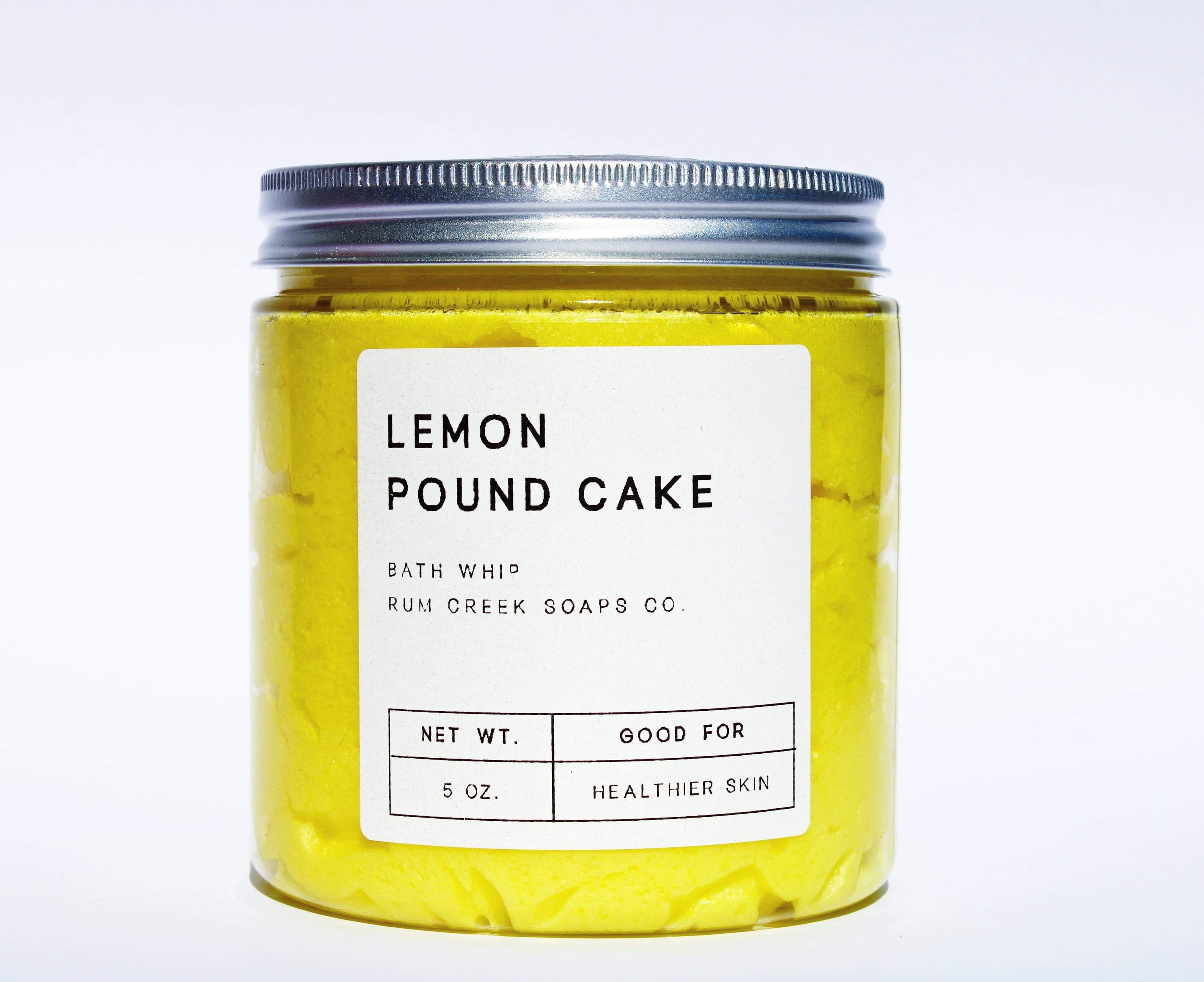 A jar of Lemon Pound Cake Whipped Soap with a fluffy texture, showcasing its vibrant yellow color and sugar crystal topping.