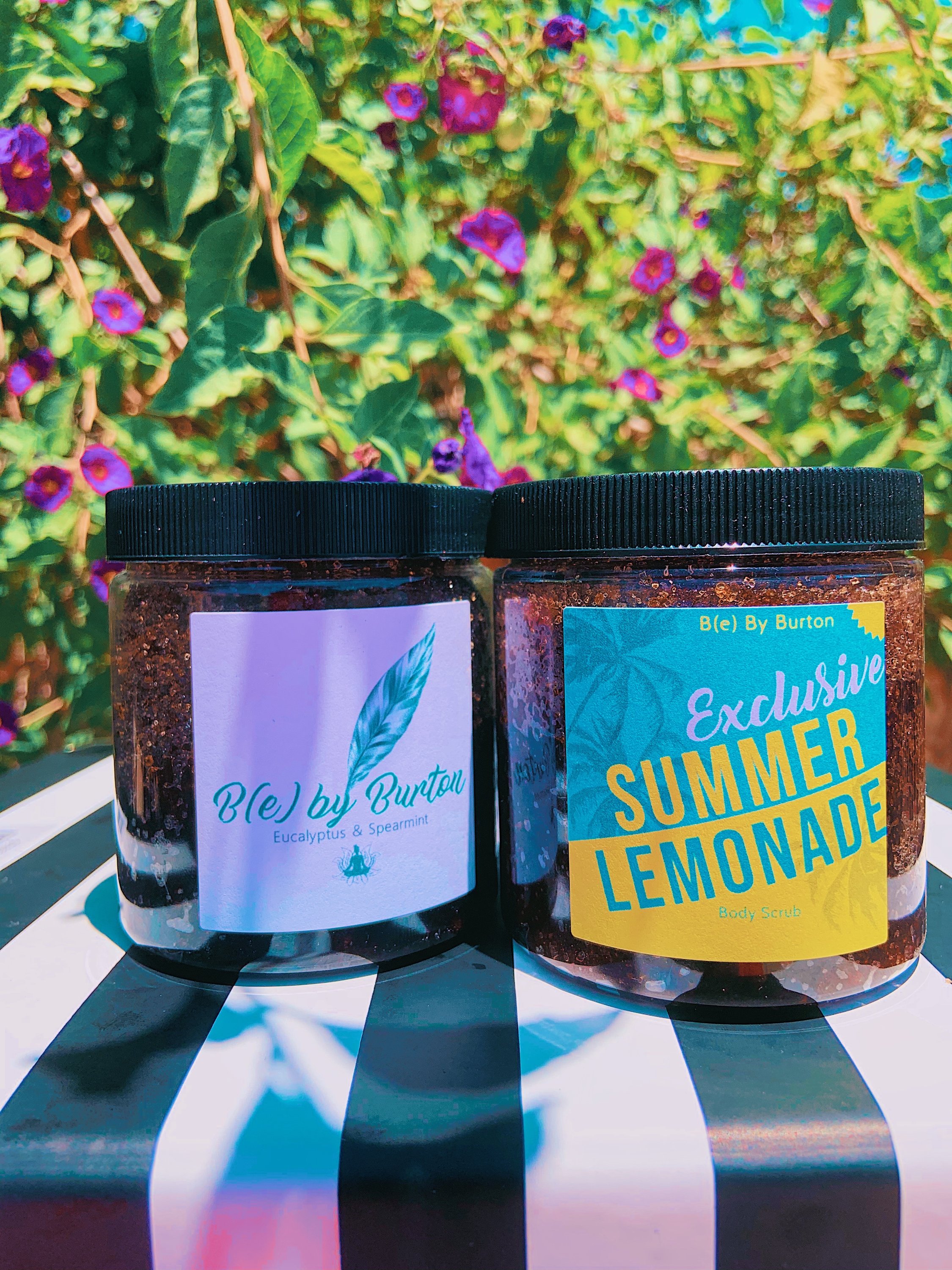 A jar of Lemonade Body Scrub featuring organic ingredients like jojoba oil and lemon essential oil, with a refreshing lemon scent.