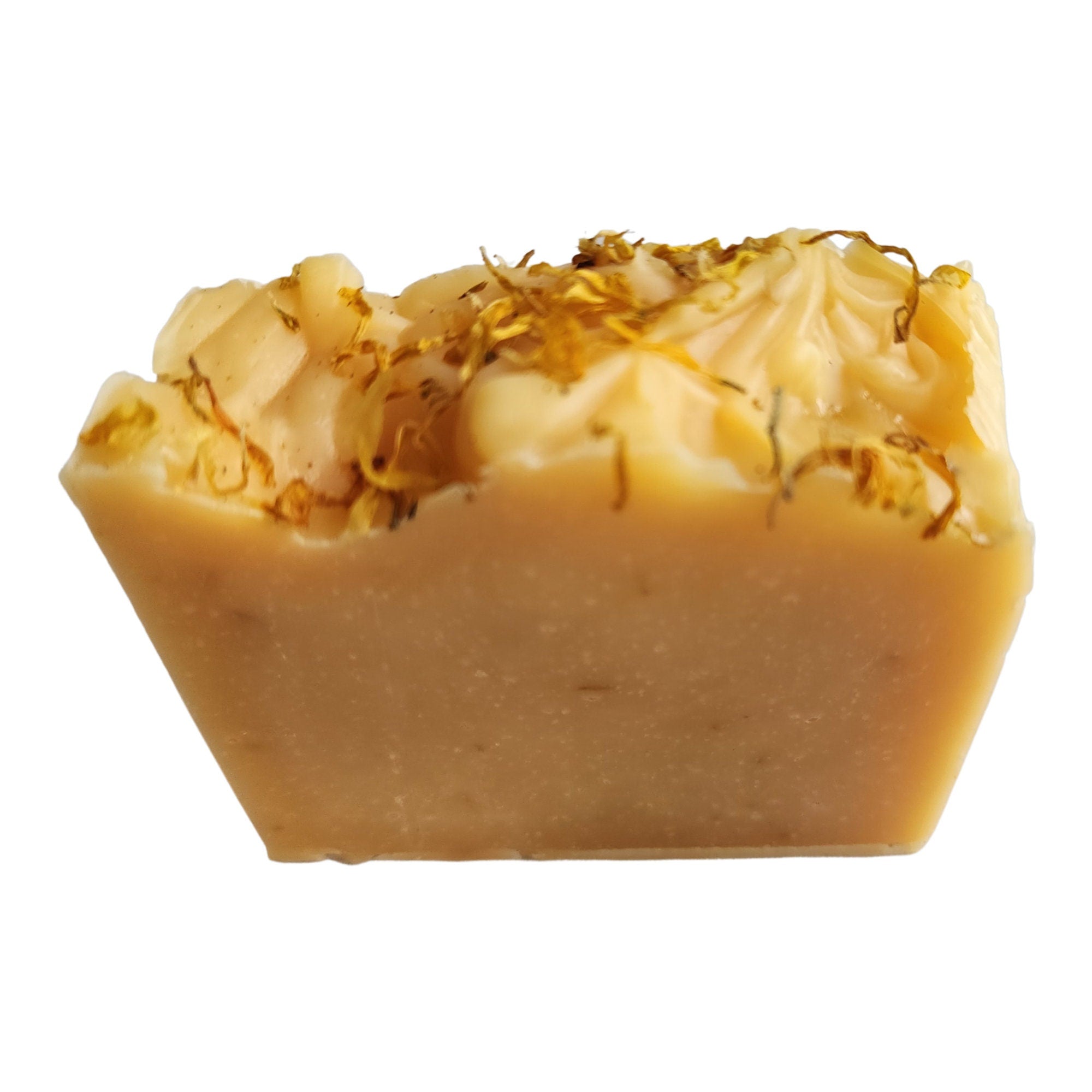 Lemongrass Calendula Soap bar topped with calendula petals, showcasing its vibrant colors and rich texture.