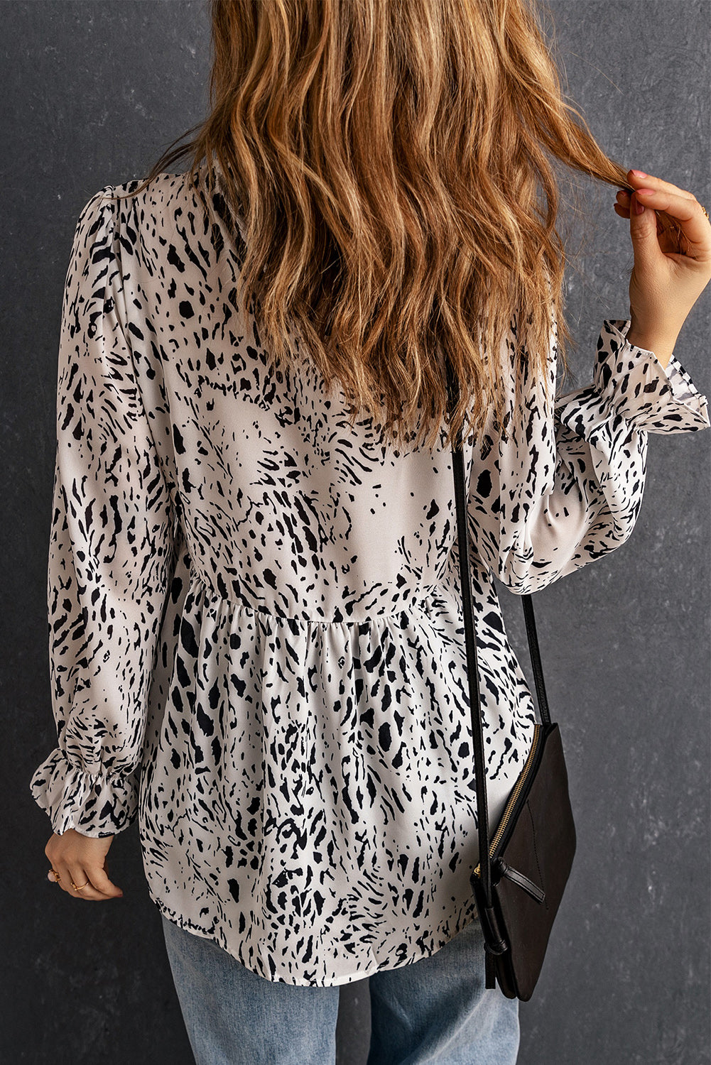 Leopard Frilled Neck Babydoll Blouse featuring a frilled neck, long sleeves, and ruffle hem in a stylish leopard print design.