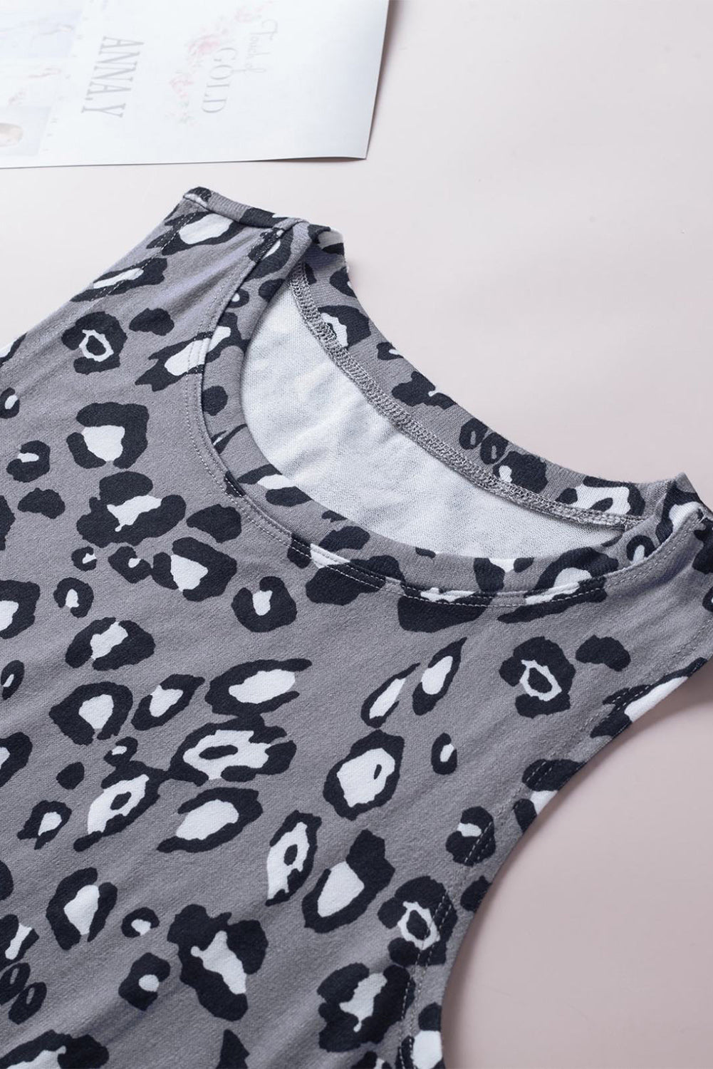 Leopard Print Crew Neck Tank Top displayed on a mannequin, showcasing its bold pattern and sleeveless design.