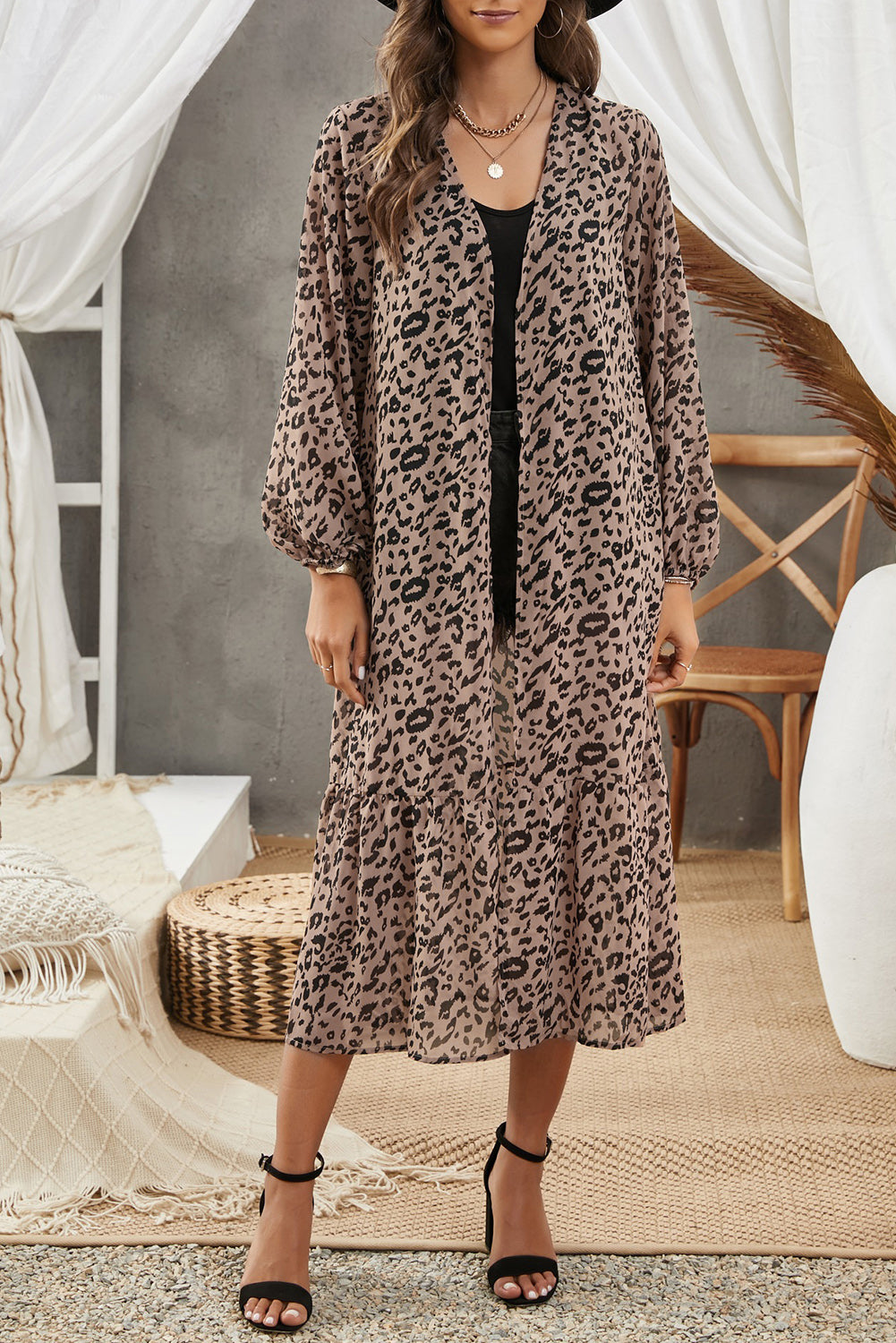 A stylish leopard print duster kimono with long sleeves and an open front, cascading to a mid-calf length, perfect for layering.