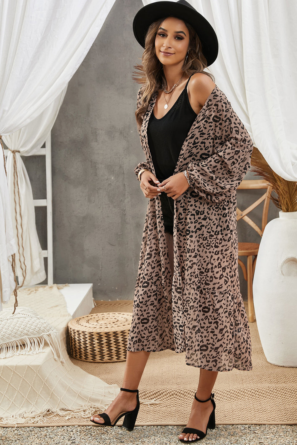 A stylish leopard print duster kimono with long sleeves and an open front, cascading to a mid-calf length, perfect for layering.