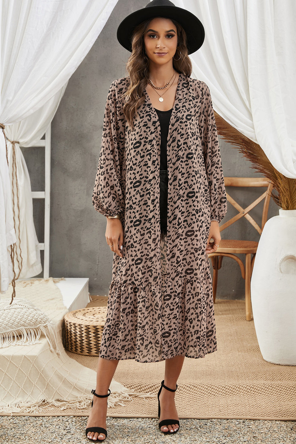 A stylish leopard print duster kimono with long sleeves and an open front, cascading to a mid-calf length, perfect for layering.