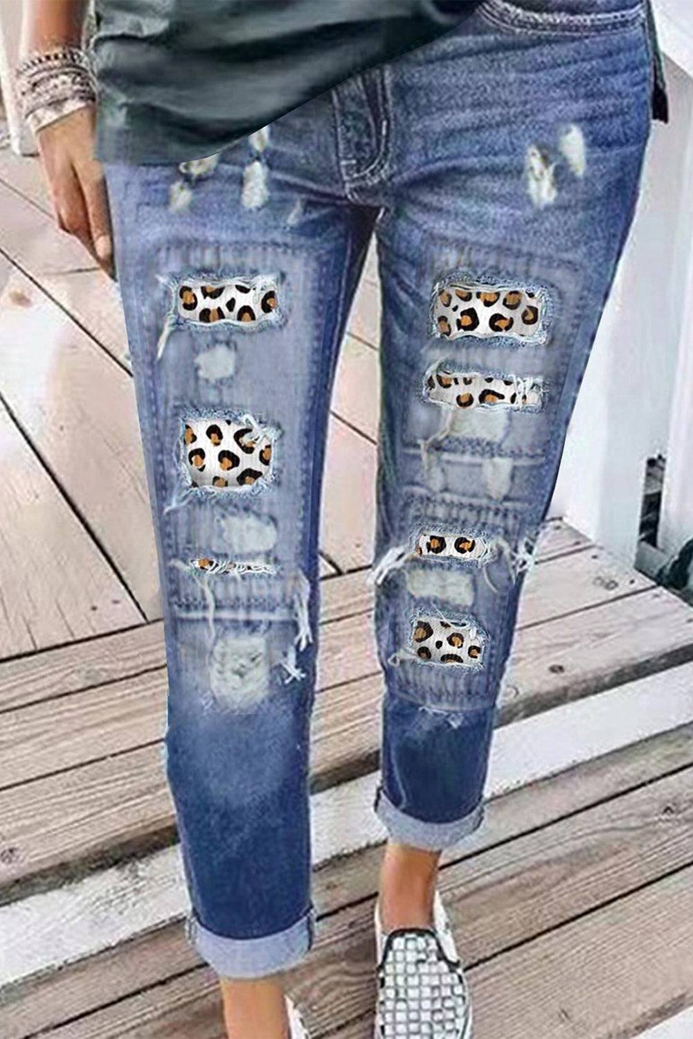 A pair of stylish leopard print ripped jeans featuring distressed patches and a high waist design, perfect for casual wear.