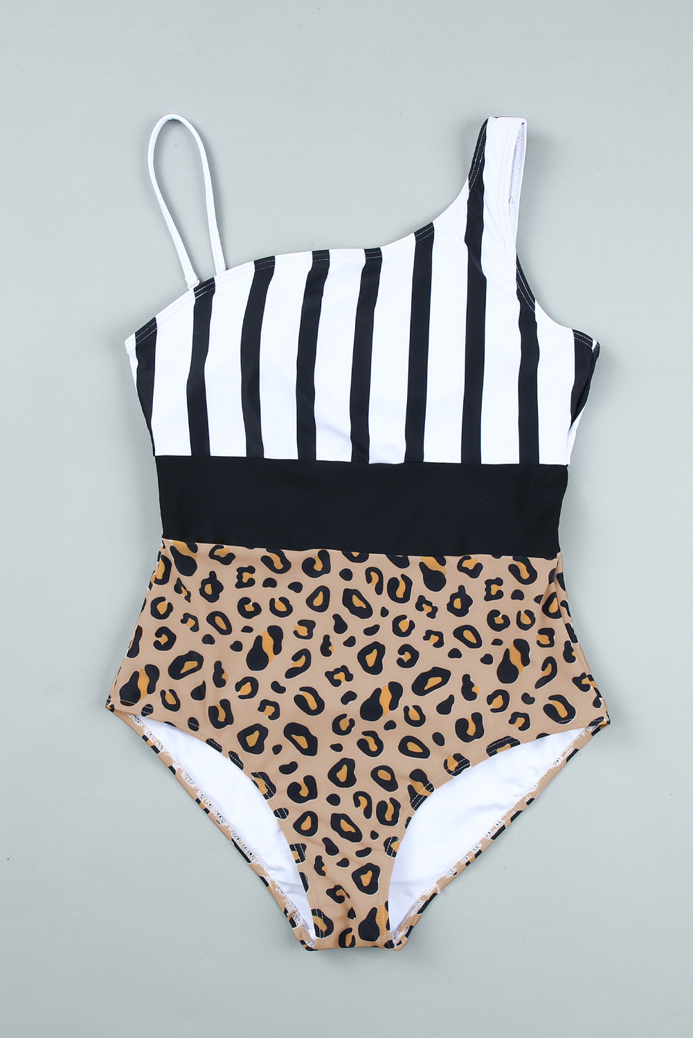 Leopard and stripes one-piece swimwear displayed on a mannequin, showcasing its stylish design and vibrant colors.