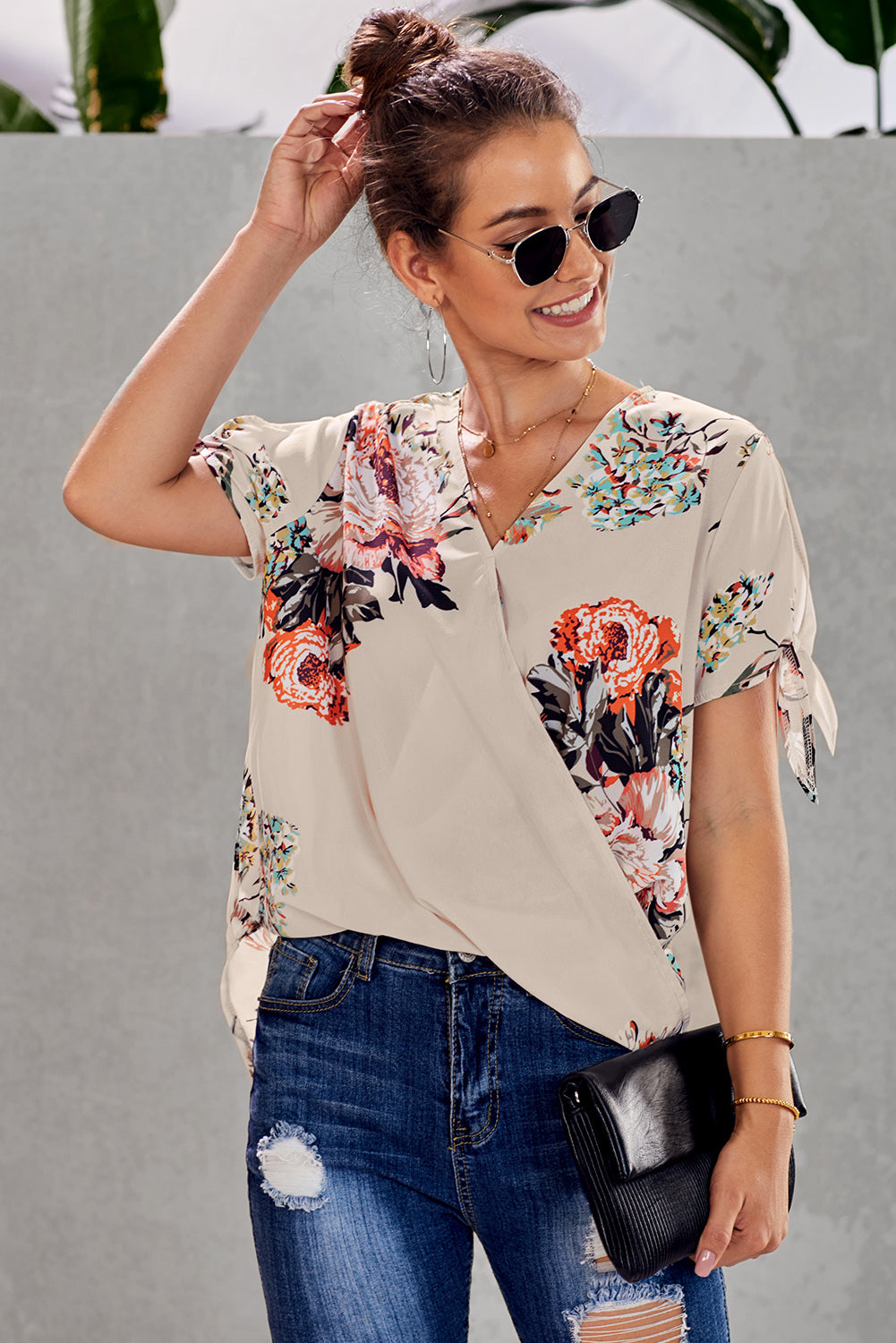 Leopard V Neck Twist Top featuring a floral print, short sleeves with slits and ties, and a stylish surplice neckline.