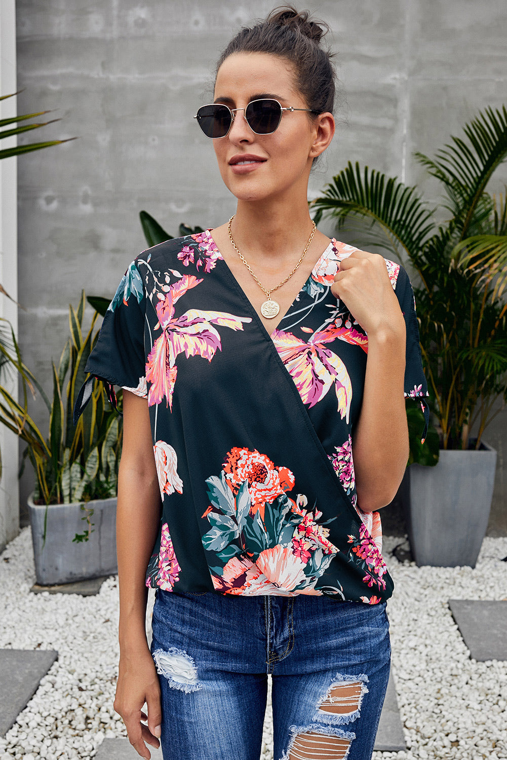 Leopard V Neck Twist Top featuring a floral print, short sleeves with slits and ties, and a stylish surplice neckline.