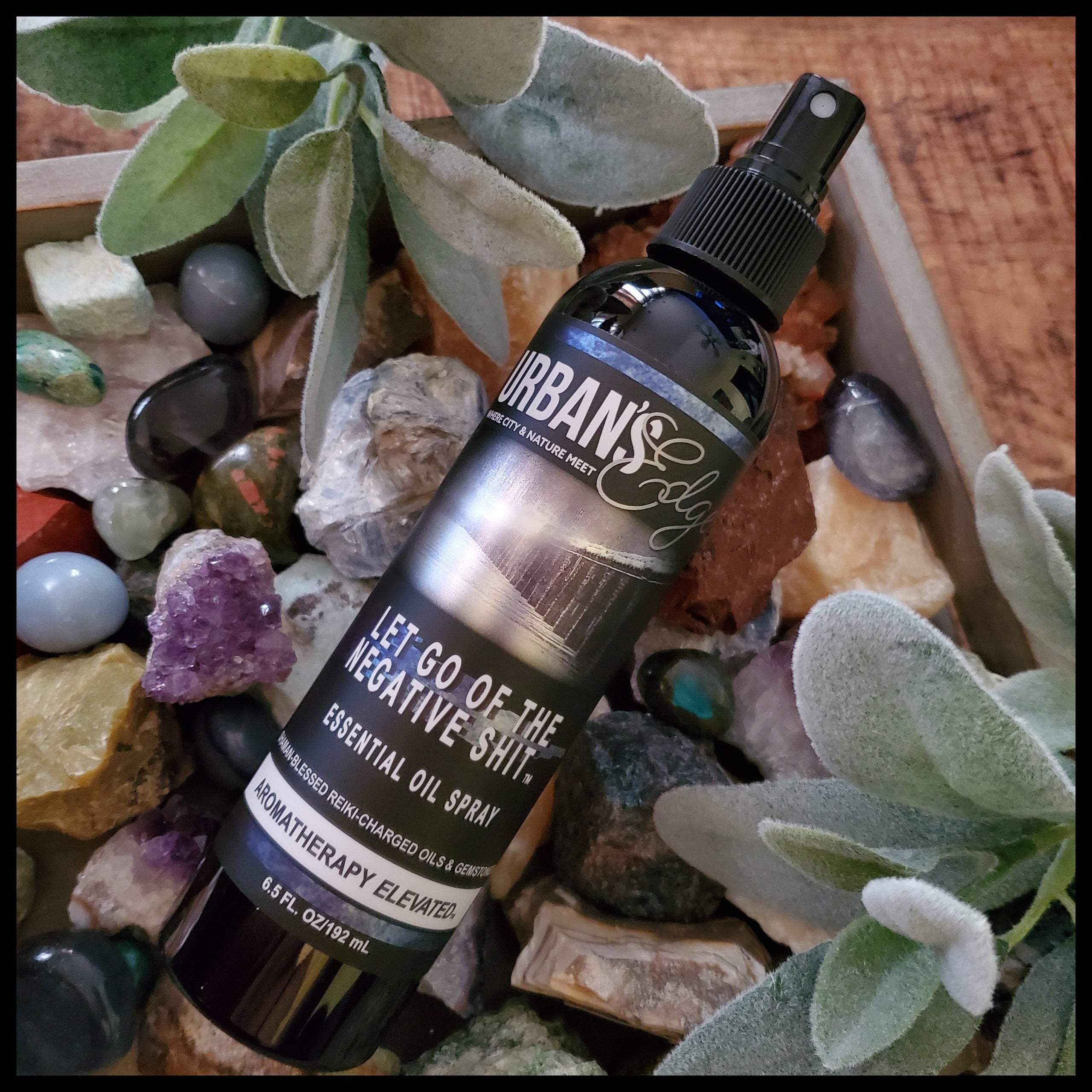 Let Go of the Negative Shit! Essential Oil Spray bottle with a calming mist, featuring natural ingredients and gemstones.