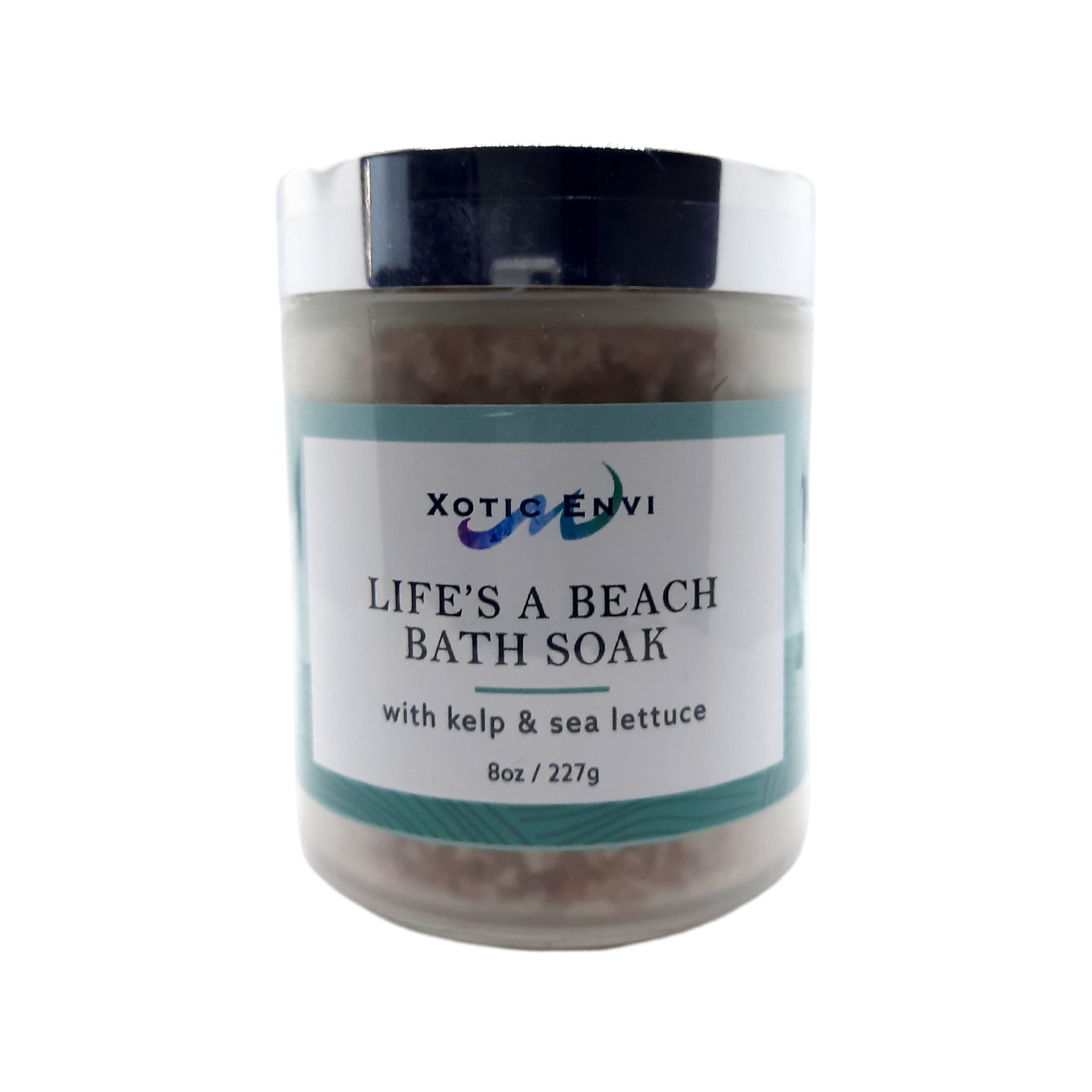 A serene bath setting featuring Life's A Beach Bath Soak with sea minerals, surrounded by calming ocean-themed decor.