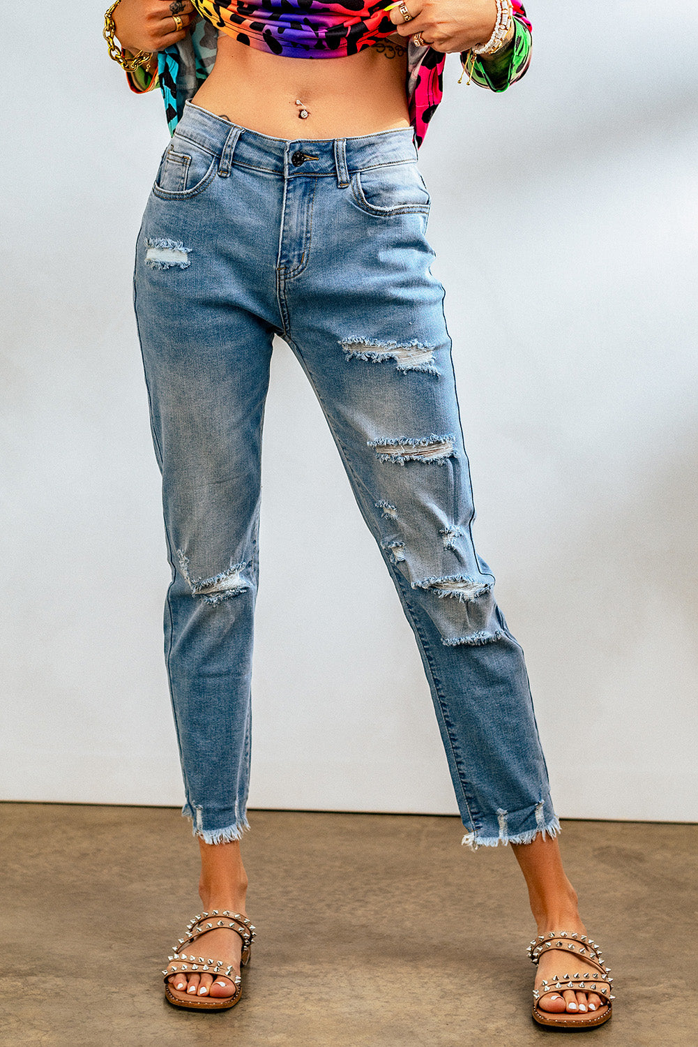 Light blue distressed boyfriend denim pants with a medium rise fit and straight leg silhouette, featuring classic five-pocket styling.