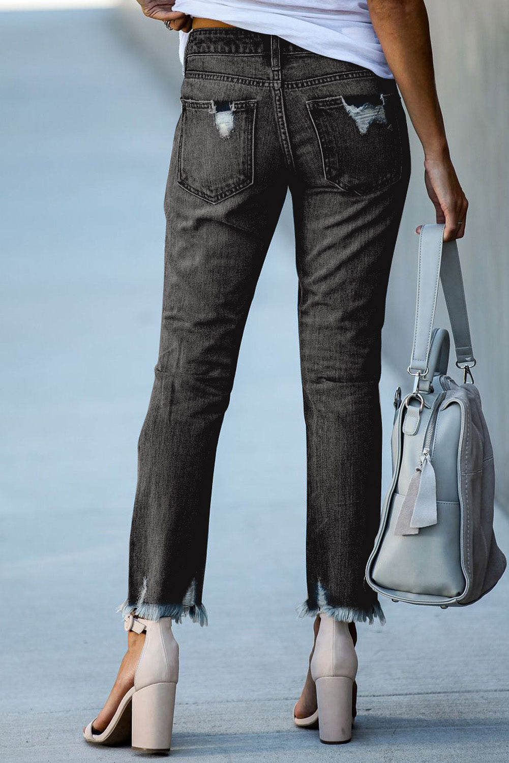 Light blue distressed boyfriend denim pants with a medium rise fit and straight leg silhouette, featuring classic five-pocket styling.