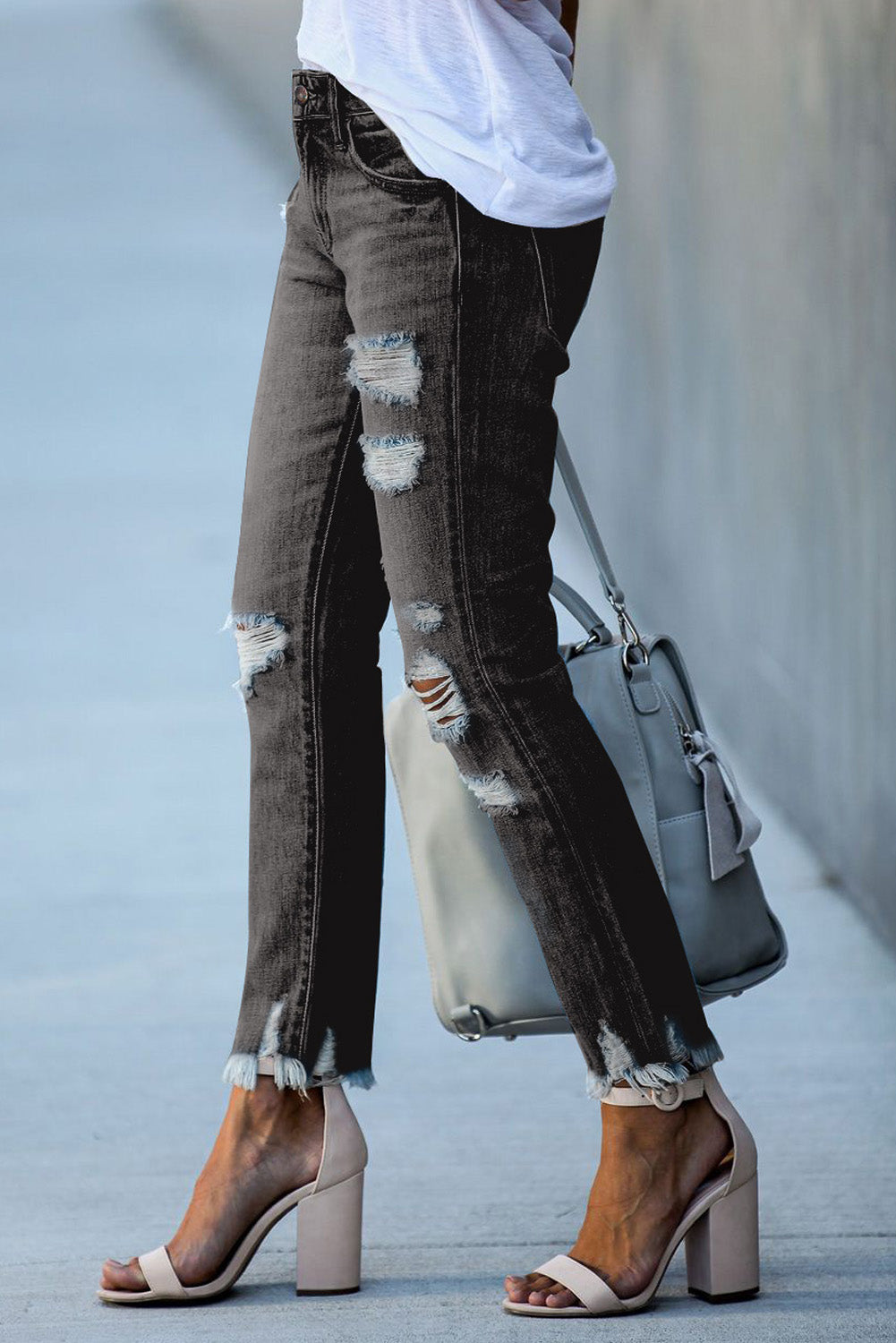 Light blue distressed boyfriend denim pants with a medium rise fit and straight leg silhouette, featuring classic five-pocket styling.