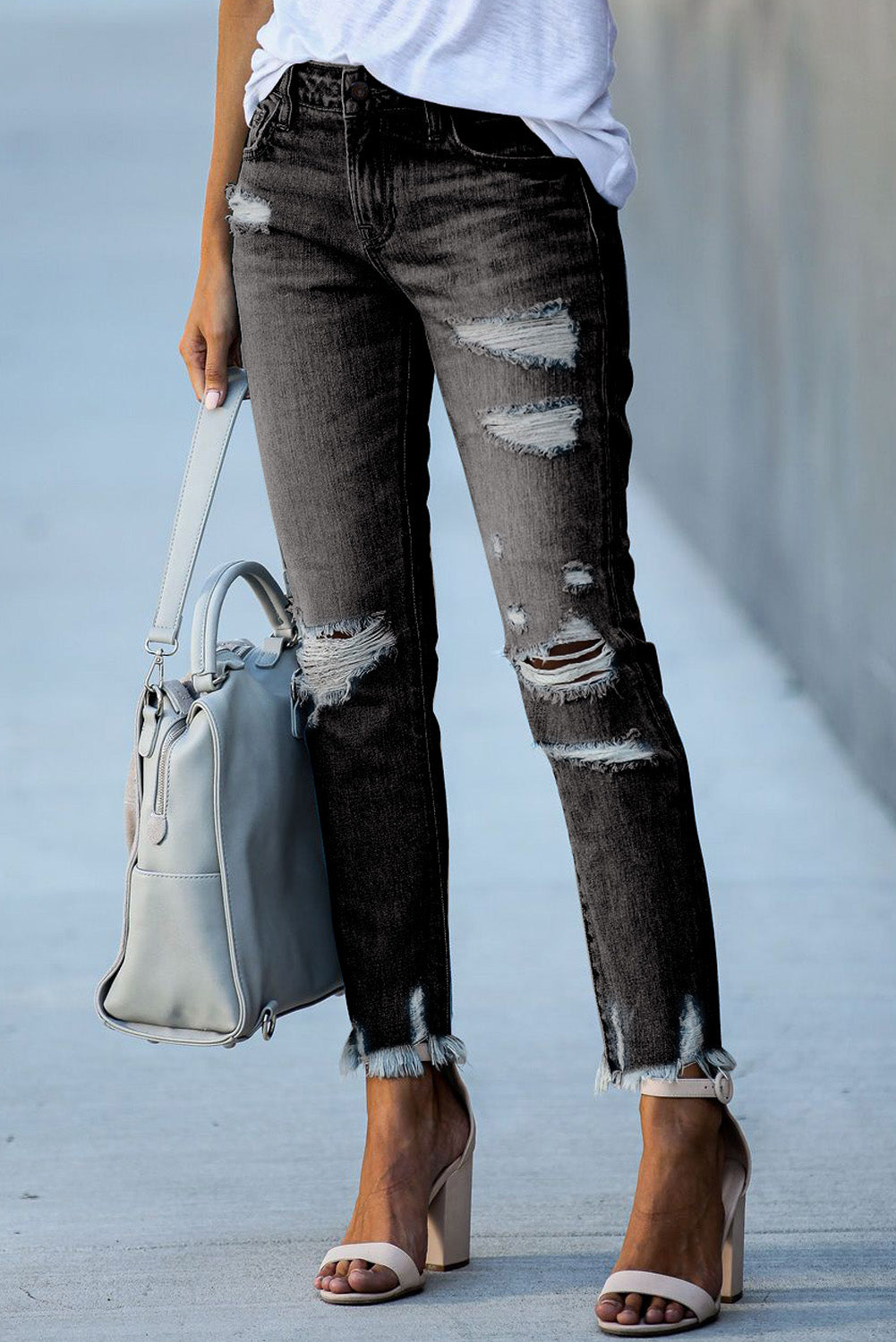 Light blue distressed boyfriend denim pants with a medium rise fit and straight leg silhouette, featuring classic five-pocket styling.