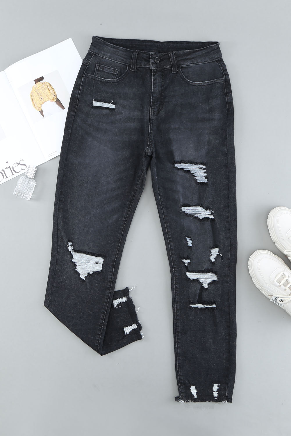 Light blue distressed boyfriend denim pants with a medium rise fit and straight leg silhouette, featuring classic five-pocket styling.