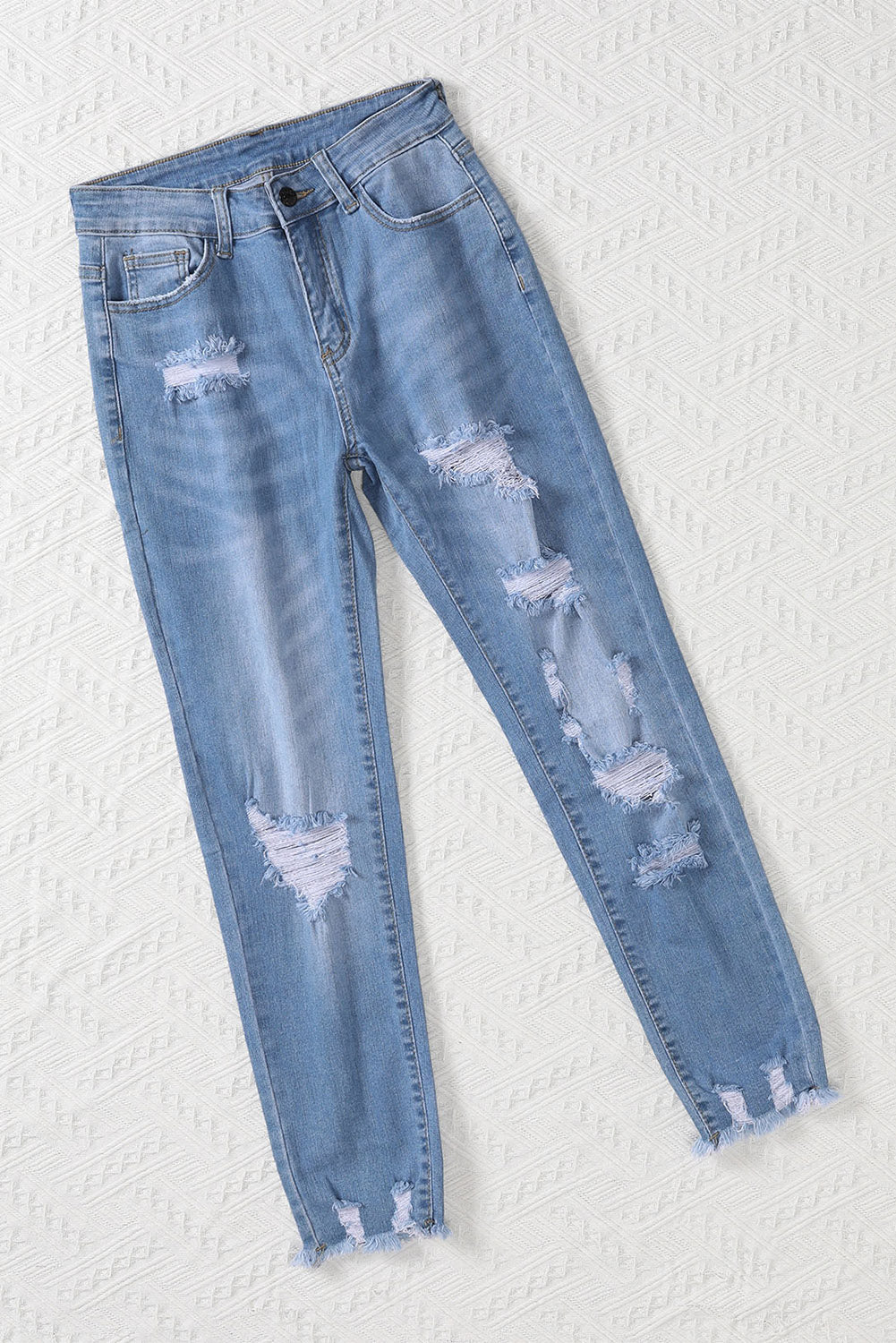 Light blue distressed boyfriend denim pants with a medium rise fit and straight leg silhouette, featuring classic five-pocket styling.