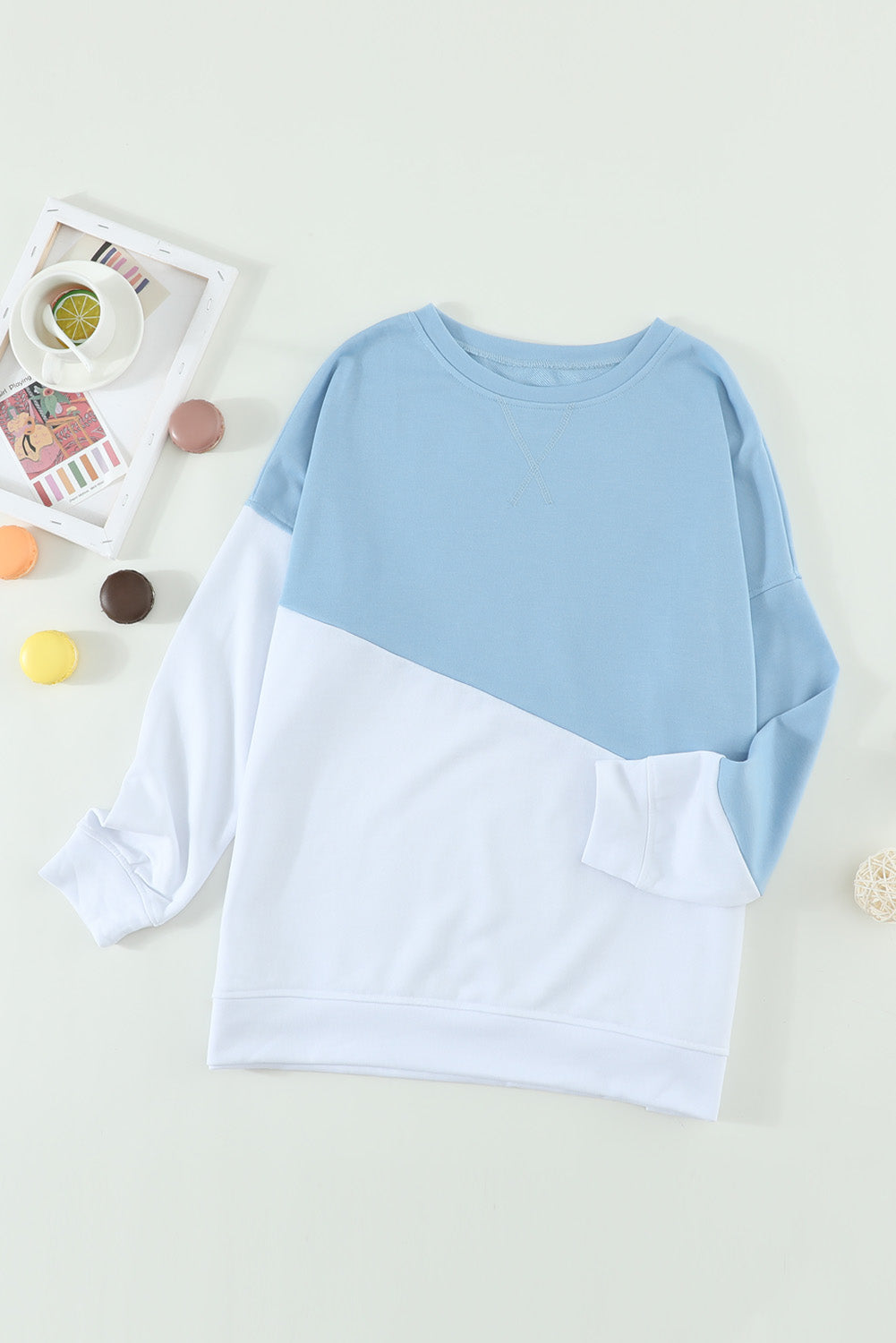 Light Blue Patchwork Dropped Shoulder Sweatshirt with color block design, showcasing a relaxed fit and soft fabric texture.