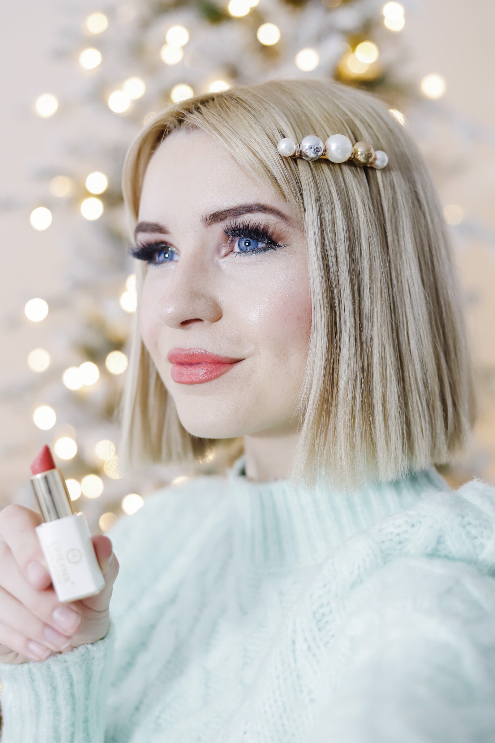 A vibrant set of vegan lip products including lip balm, lipsticks, and lip gloss in various colors, displayed elegantly.