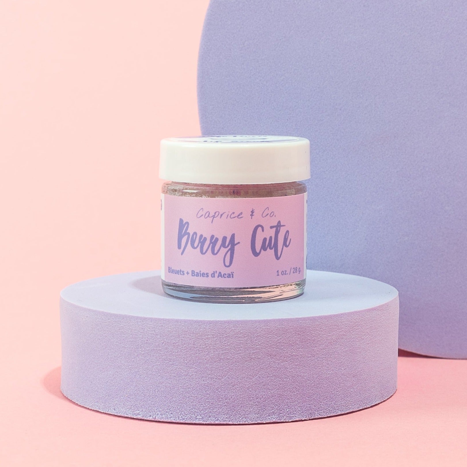 Berry Cute Lip Scrub in a jar with acai berries and blueberries, showcasing its natural ingredients and vibrant color.