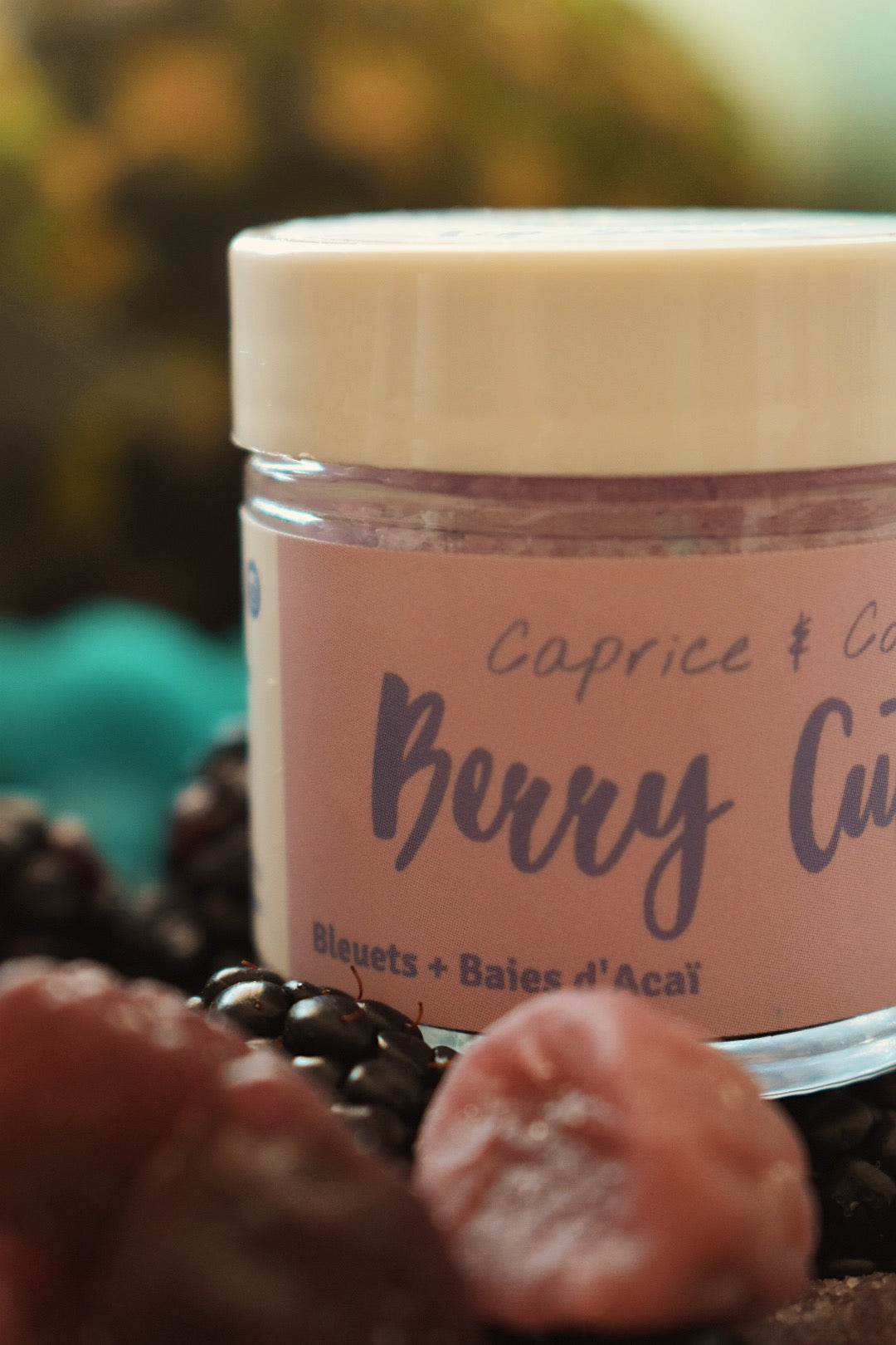 Berry Cute Lip Scrub in a jar with acai berries and blueberries, showcasing its natural ingredients and vibrant color.