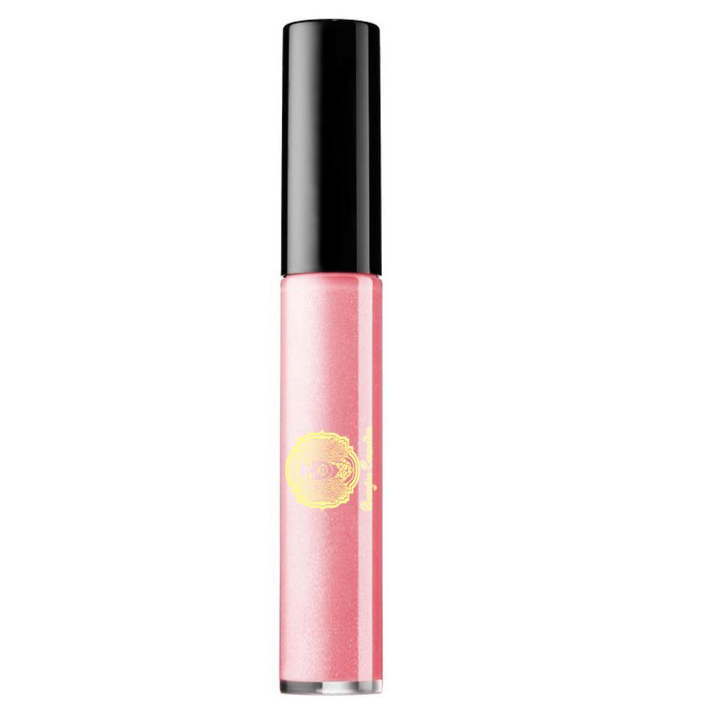 Lipgloss Disco in clear salmon melon shade with a creme texture, showcasing its glossy finish and stylish packaging.