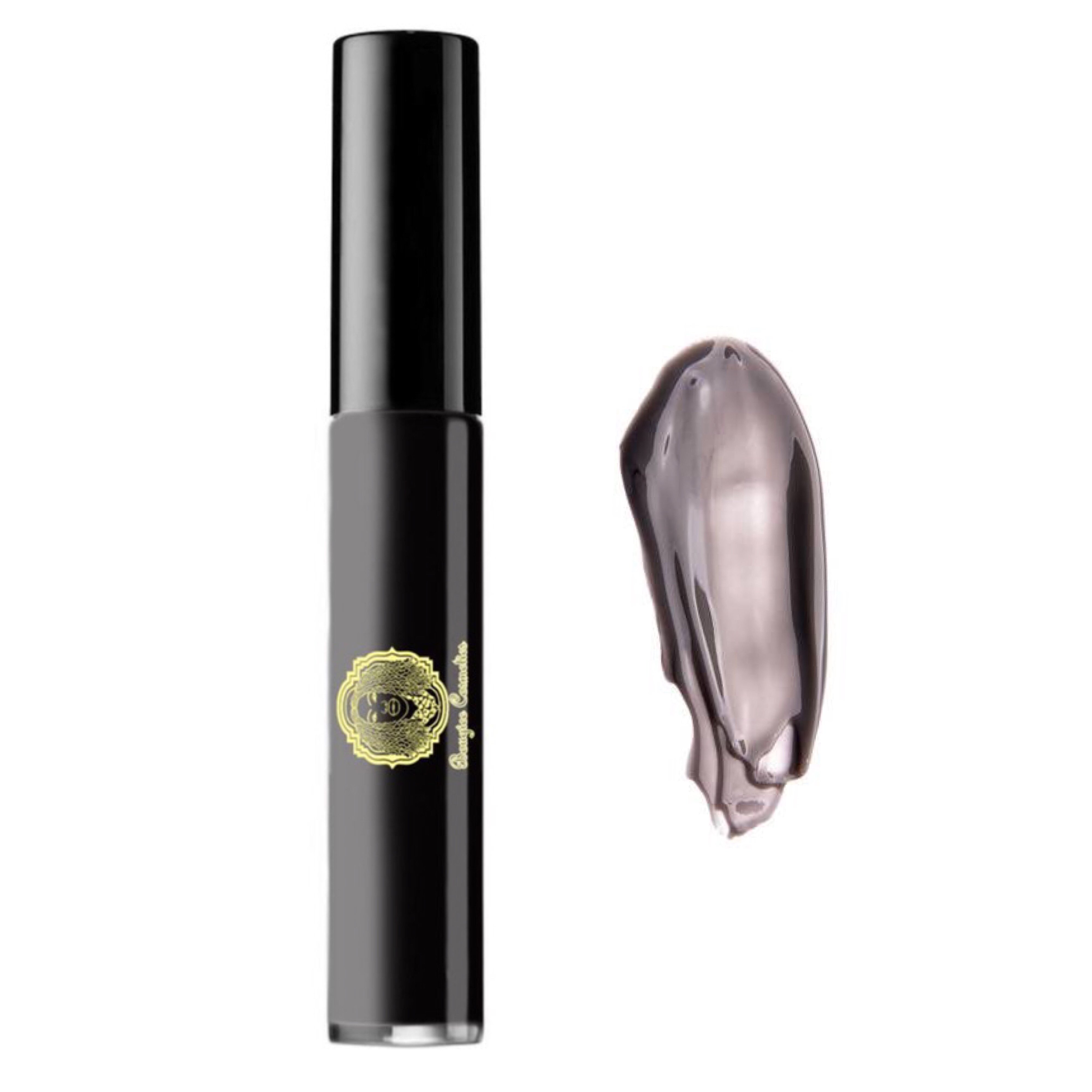 A sleek tube of Lipgloss Noir featuring a sheer cream black formula, showcasing its glossy finish and elegant design, perfect for achieving a wet look.