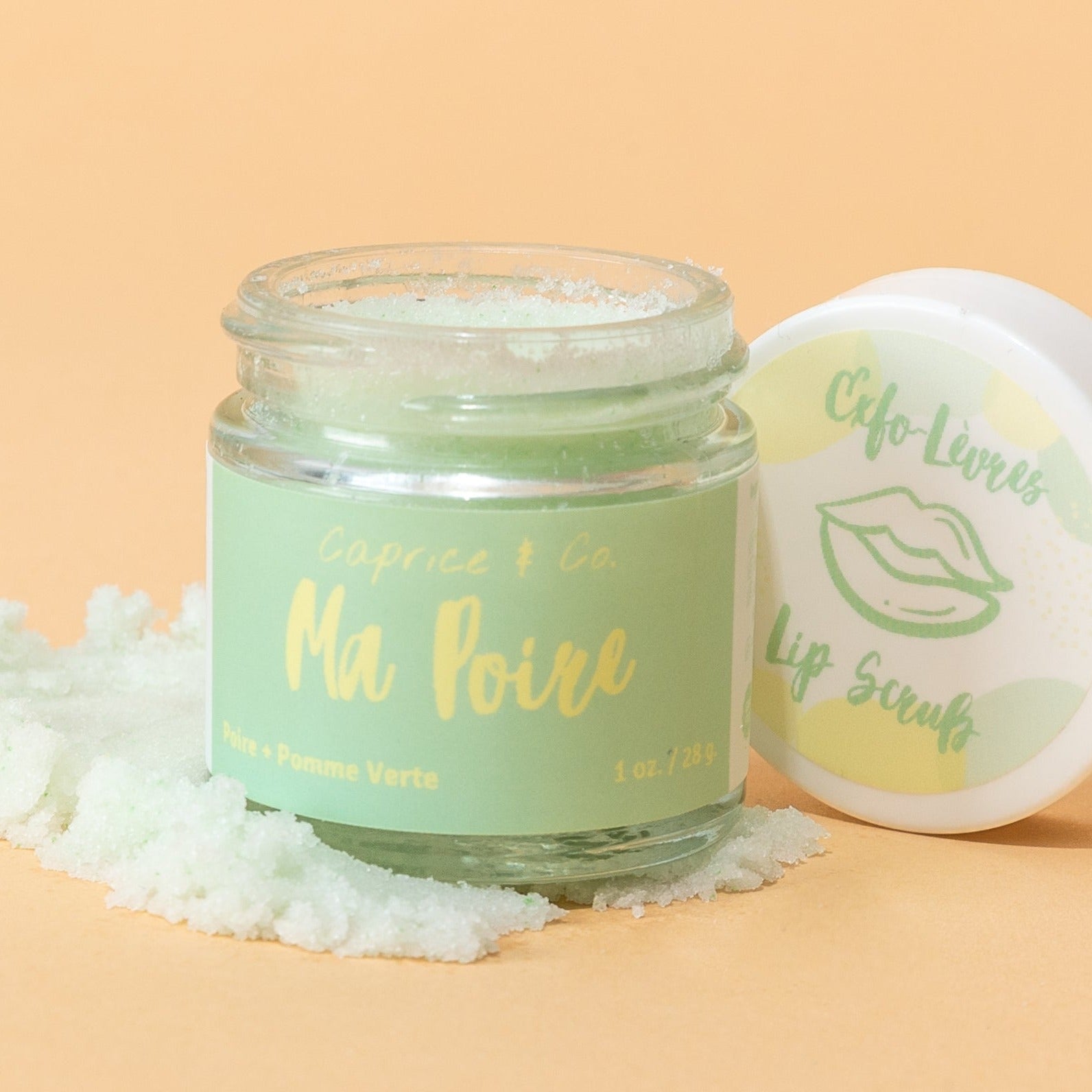 Ma Poire Lip Scrub in a jar with a pear and green apple flavor, showcasing its natural ingredients and handmade quality.