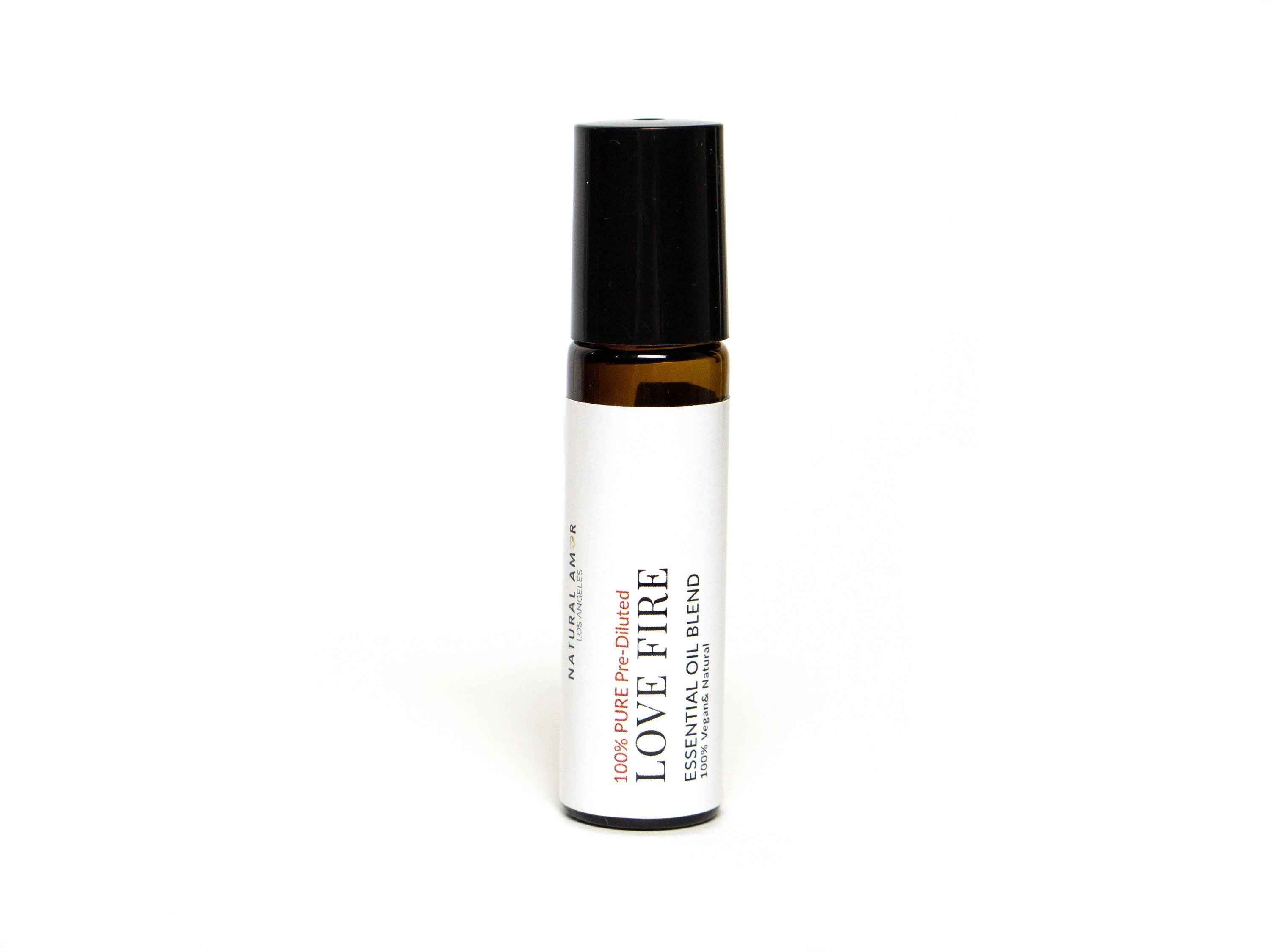 Love Fire Roll On Essential Oil Blend in a 10 mL bottle with a stainless steel rollerball, featuring a floral and woodsy scent.