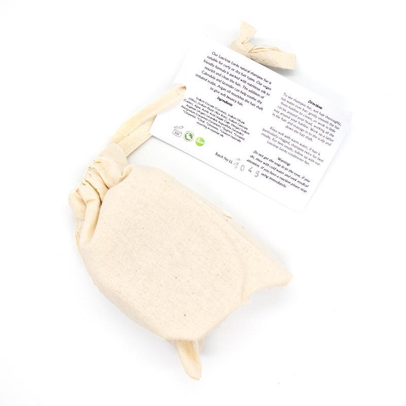 Luscious Locks Organic Shampoo Bar with natural ingredients, suitable for curly and dry hair types, packaged in eco-friendly cotton bag.