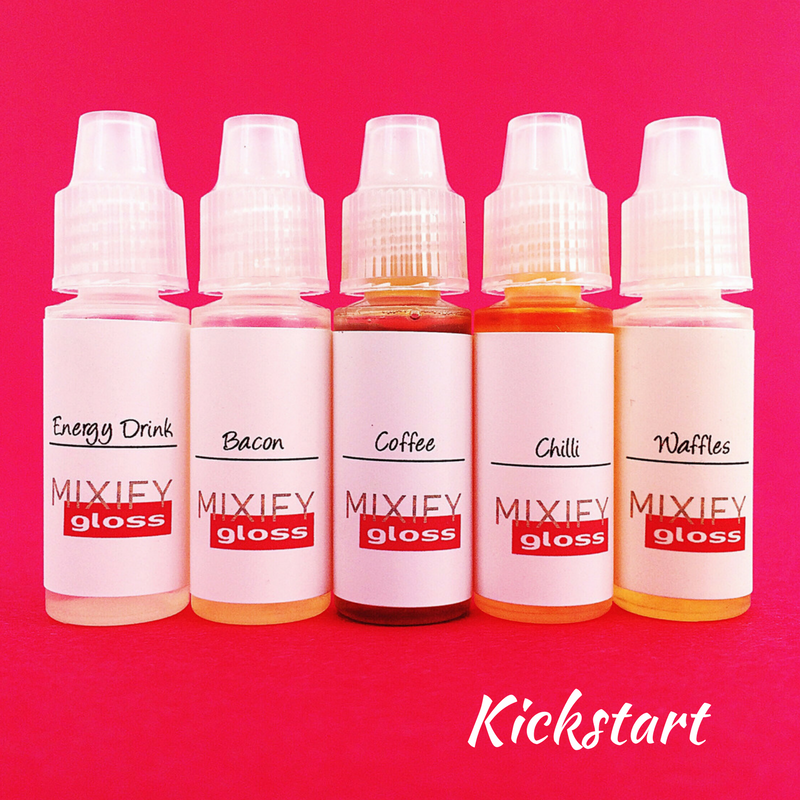 A colorful display of the Make Your Own Lip Oil Gloss Kit, featuring various flavors and color tints for custom lip gloss creation.