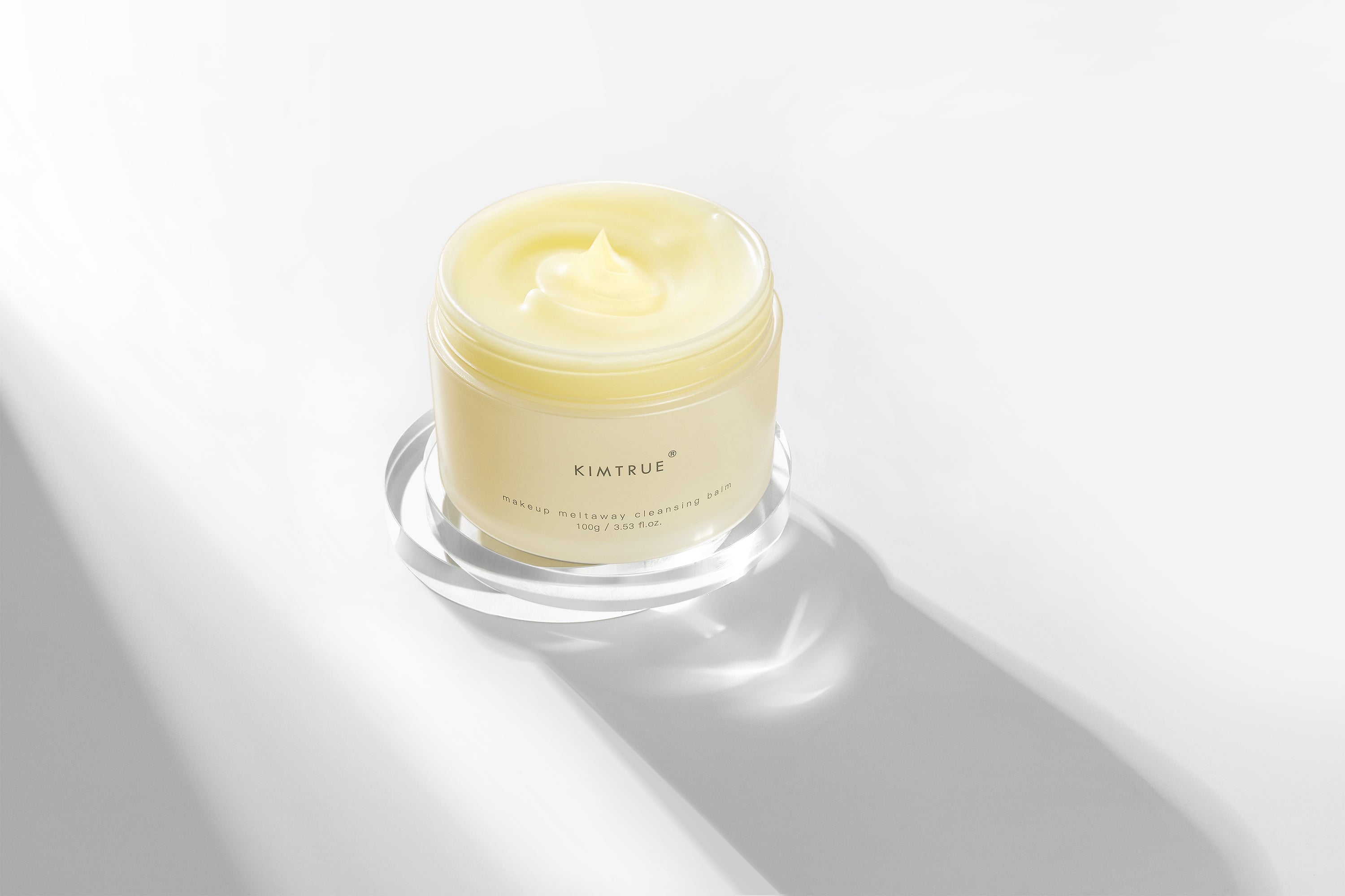 Makeup Meltaway Cleansing Balm in a sealed plastic container, showcasing its rich texture and natural ingredients like bilberry and moringa seed extracts.