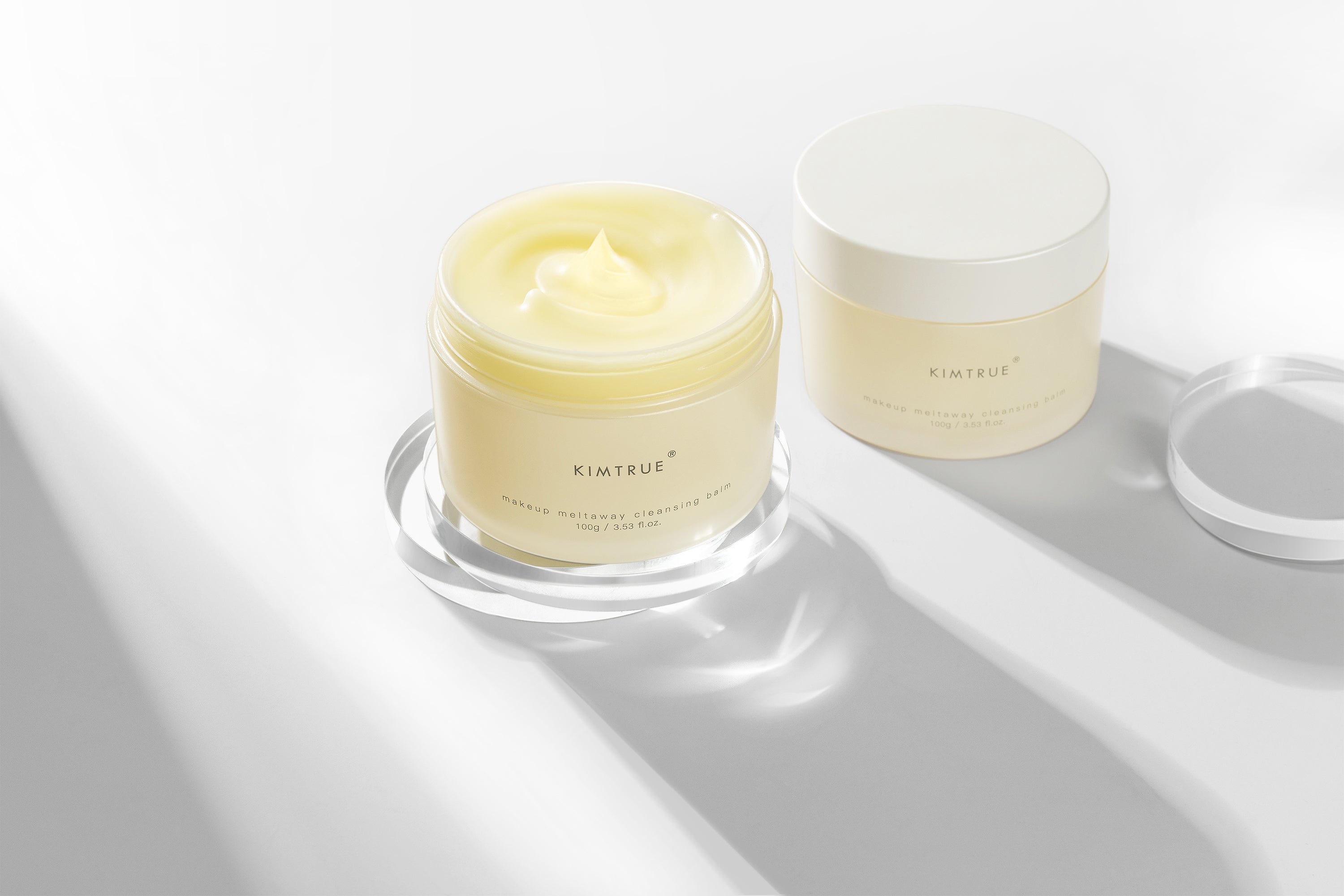 Makeup Meltaway Cleansing Balm in a sealed plastic container, showcasing its rich texture and natural ingredients like bilberry and moringa seed extracts.