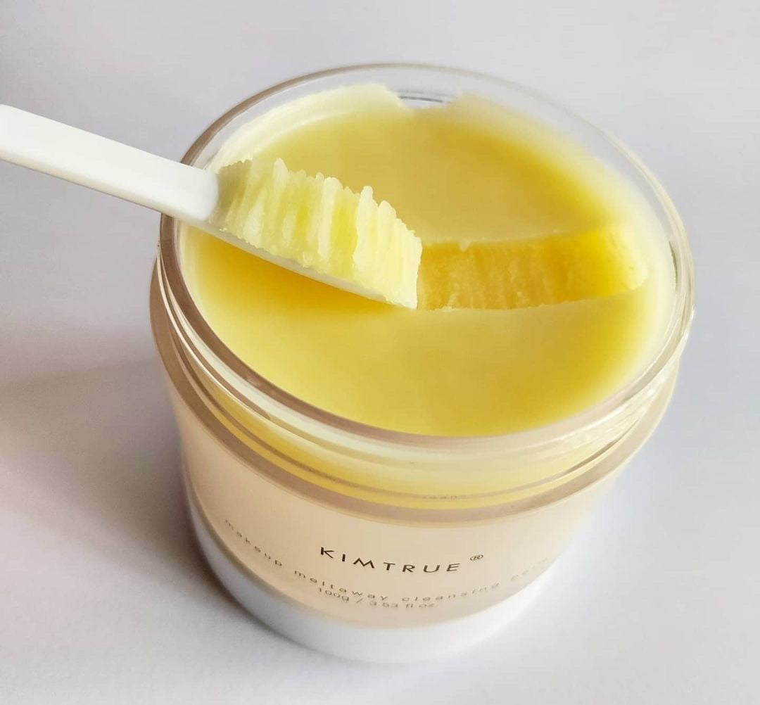 Makeup Meltaway Cleansing Balm in a sealed plastic container, showcasing its rich texture and natural ingredients like bilberry and moringa seed extracts.