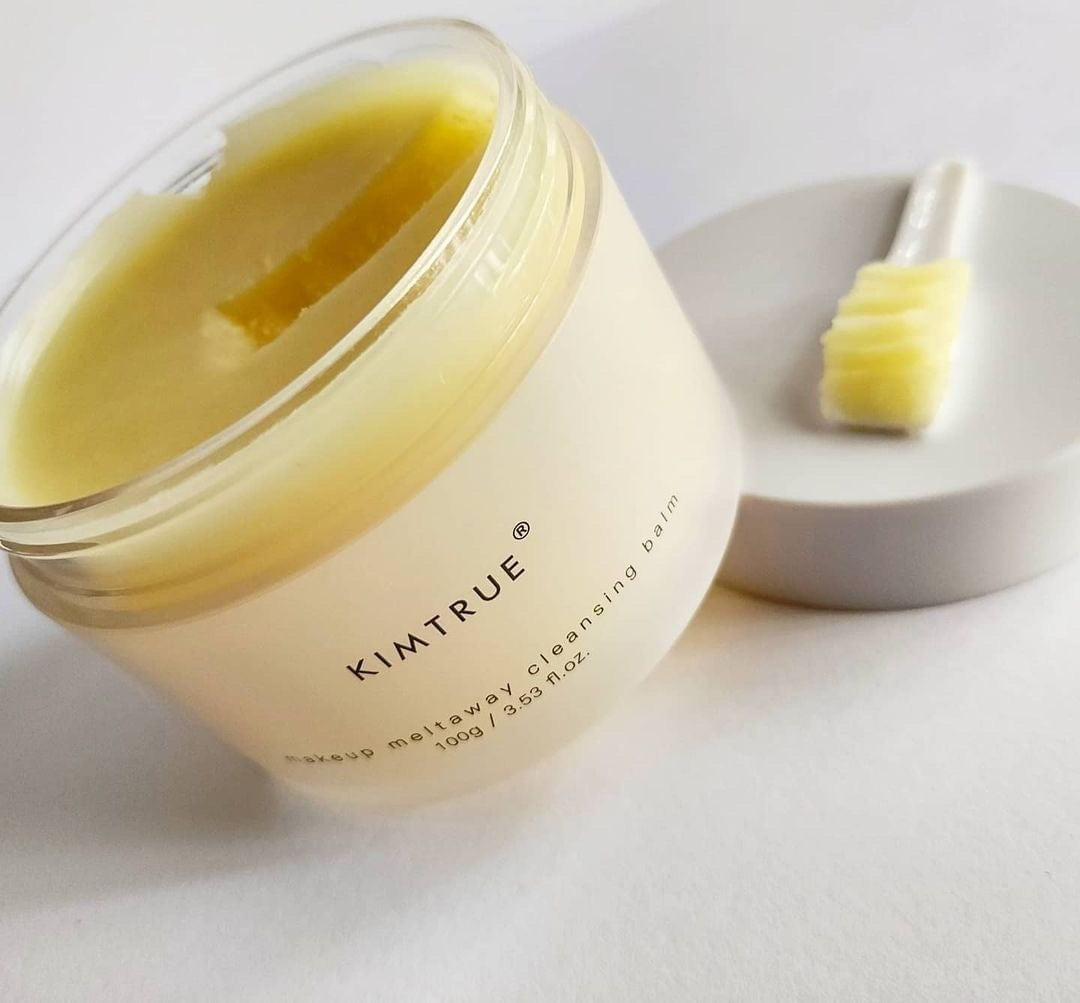 Makeup Meltaway Cleansing Balm in a sealed plastic container, showcasing its rich texture and natural ingredients like bilberry and moringa seed extracts.