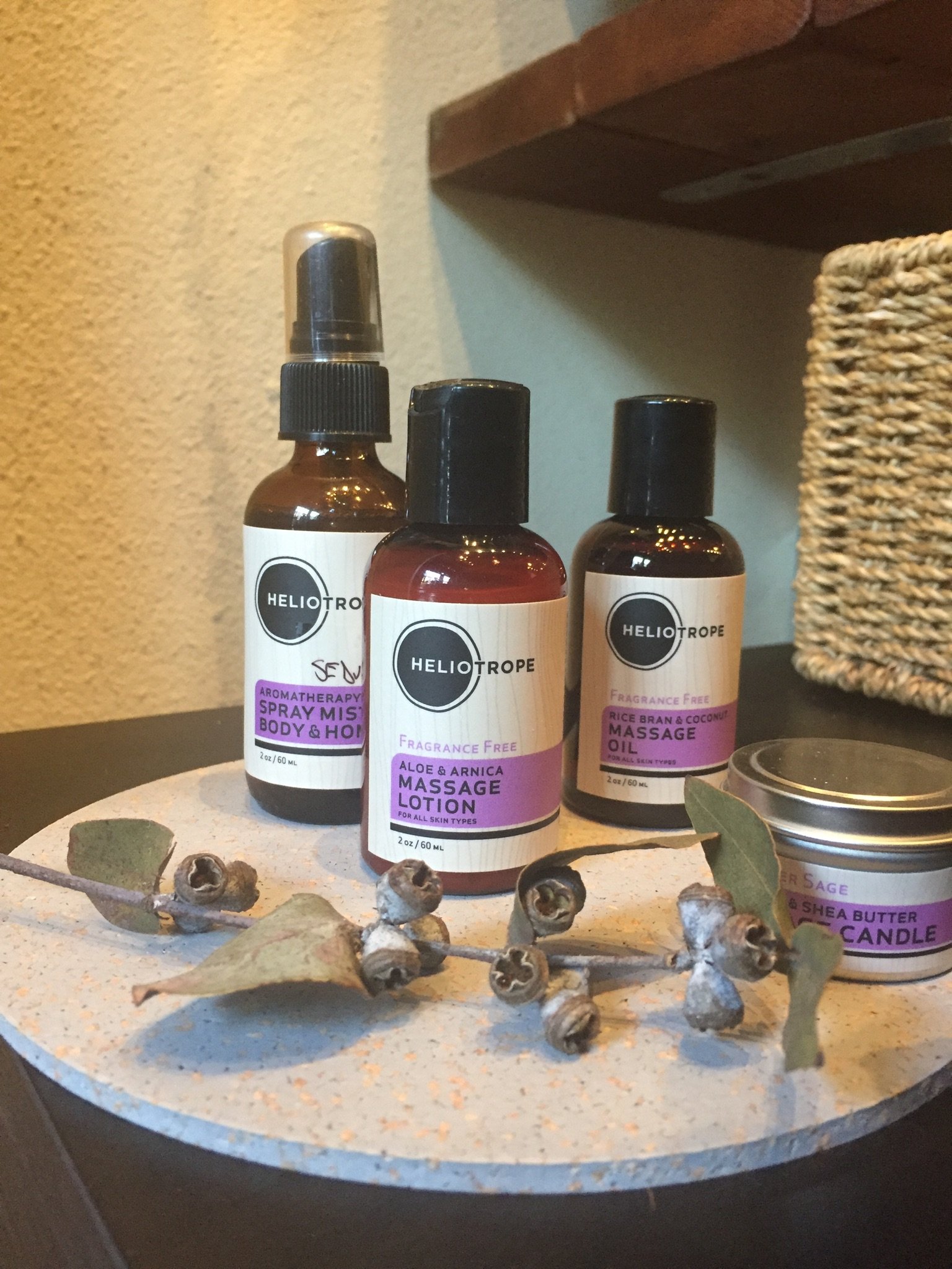 Massage Travel Sampler kit featuring lotion, oil, aromatherapy spray, and candle in a vinyl travel bag.