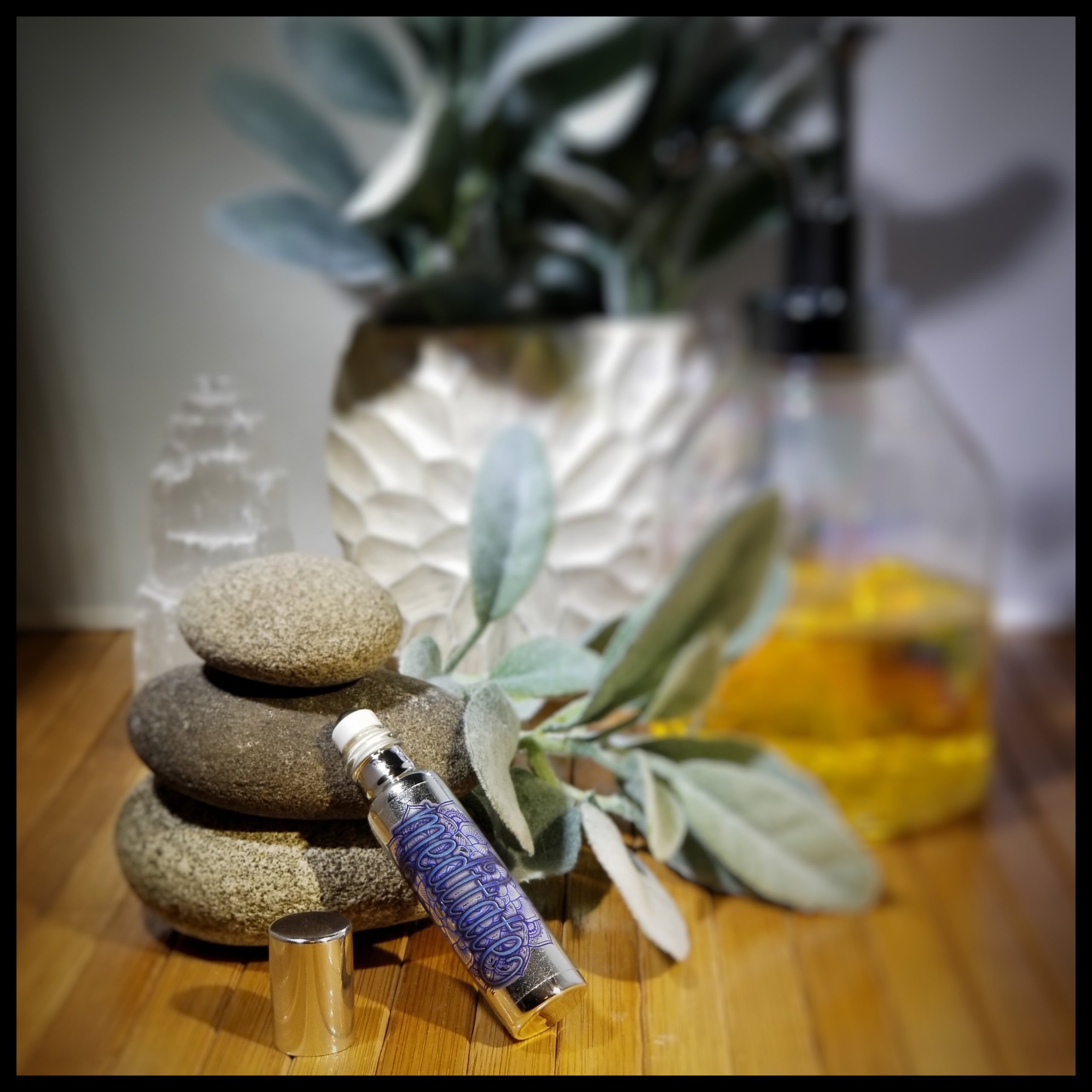 Meditate Essential Oil Roll-On in a stylish metallic glass bottle, designed for enhancing meditation with essential oils and gemstones.