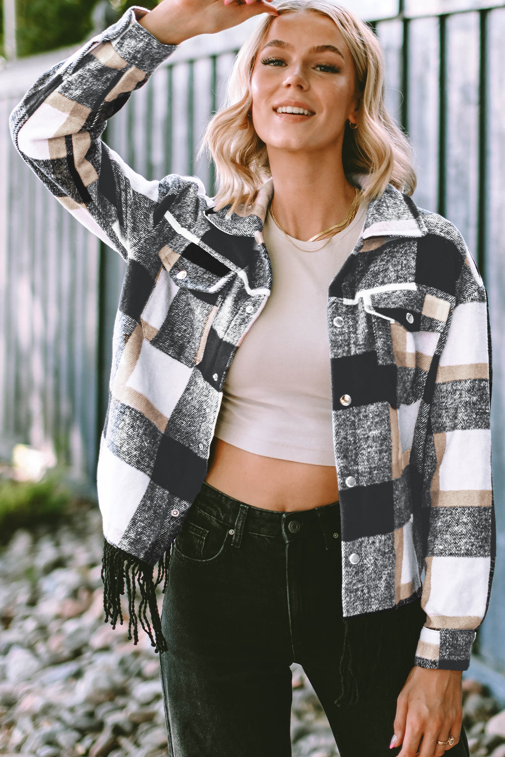 A stylish medium grey plaid jacket featuring a fringed hem, metal snap buttons, and two chest pockets, perfect for layering.