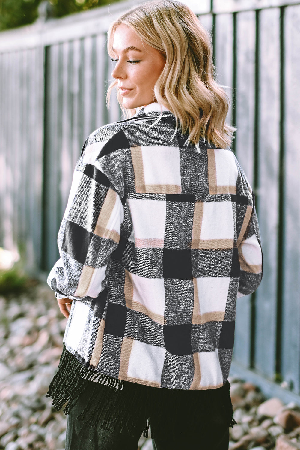 A stylish medium grey plaid jacket featuring a fringed hem, metal snap buttons, and two chest pockets, perfect for layering.